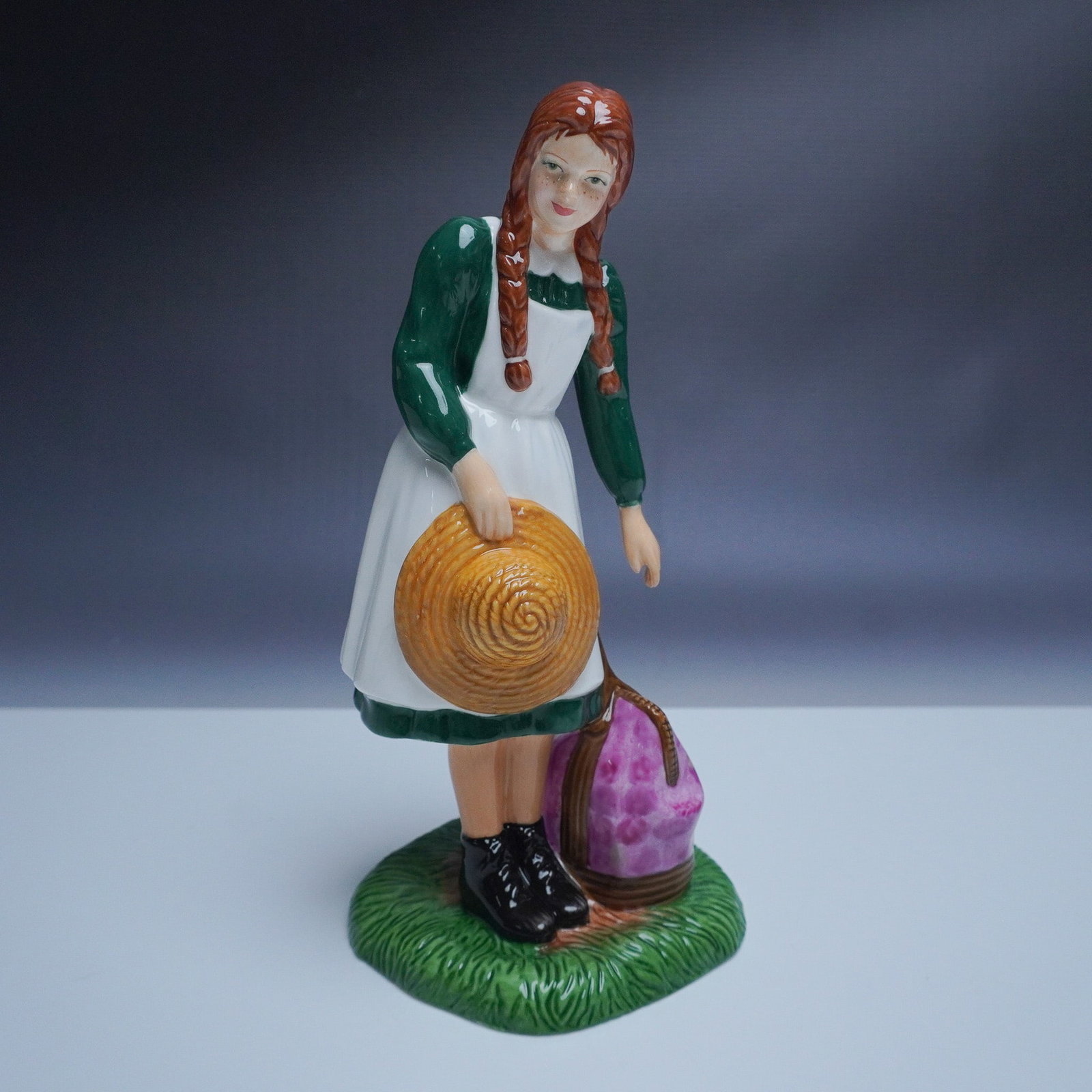 Royal Doulton Petites Figurine, Anne Arrives at Green Gables: Royal Doulton Petites figurine Anne Arrives at Green Gables, model HN5225. This beautifully hand-decorated bone china figurine portrays Anne Shirley from Anne of Green Gables, standing beside her trav