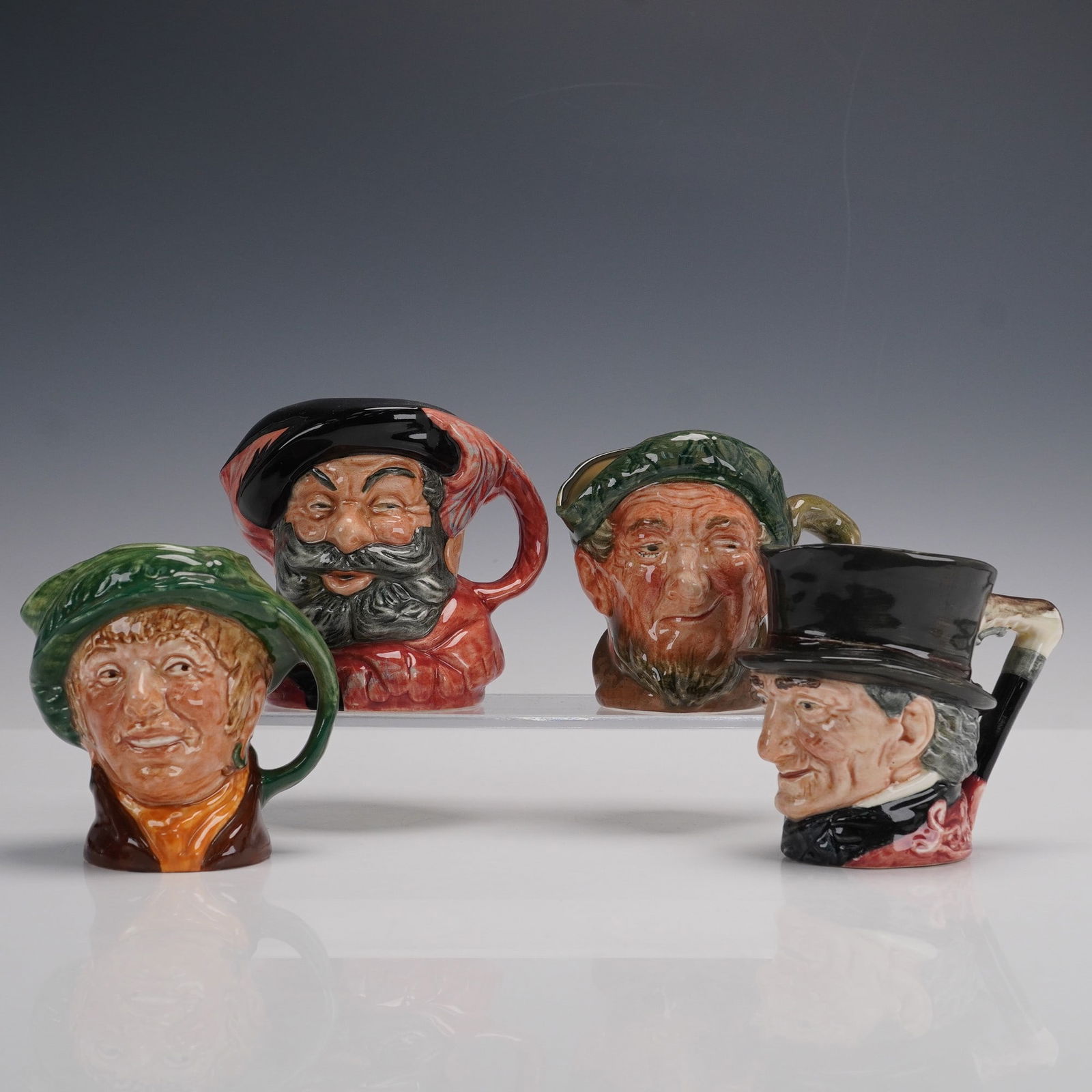 4pc Royal Doulton 3 Small Character Jugs + Falstaff Lighter D6385: Collection of four Royal Doulton character jugs, including three small size jugs and one novelty lighter. The group features John Peel, depicted in green cap with a cheerful hunting expression; Owd Ma