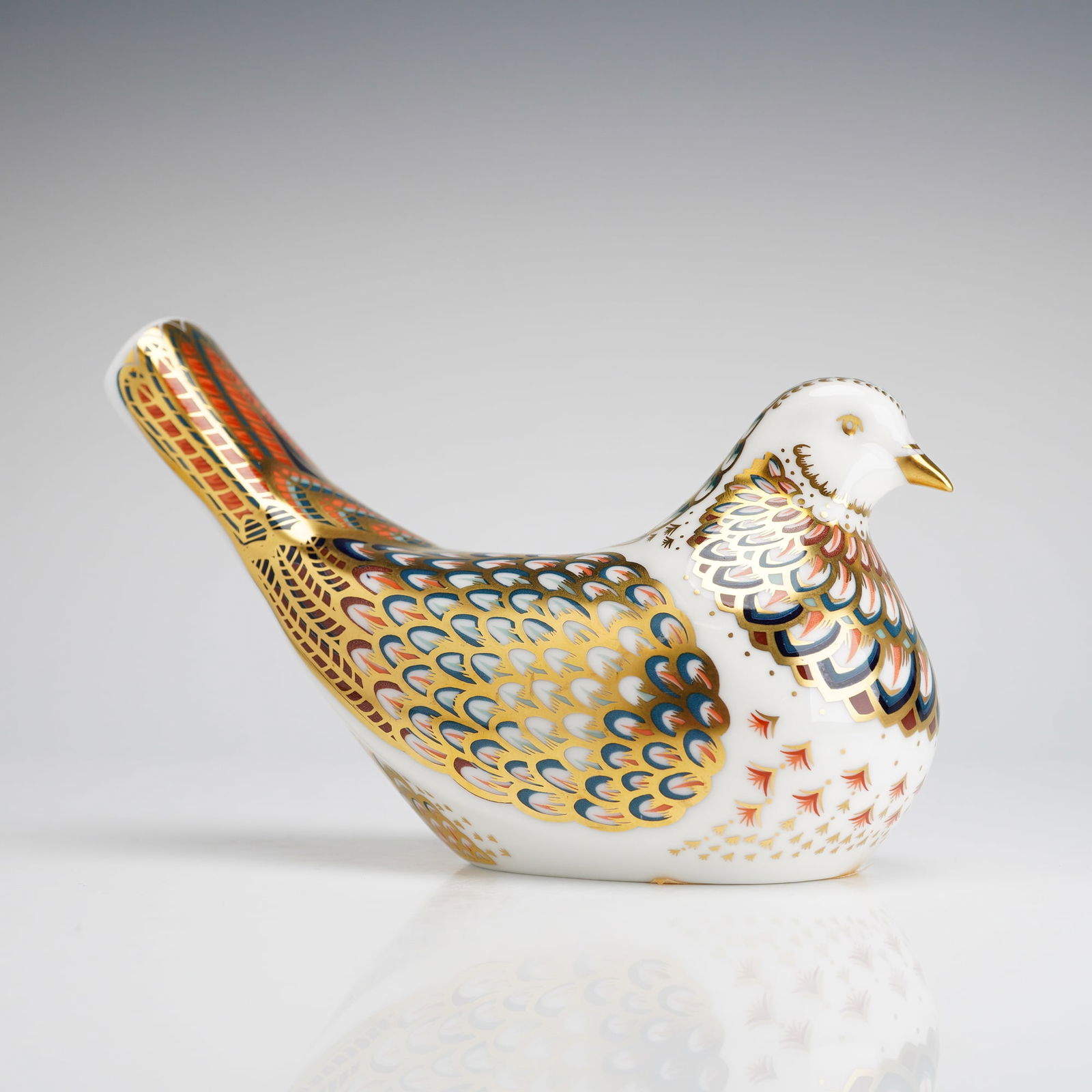 Royal Crown Derby Turtle Dove Paperweight: A Royal Crown Derby bone china paperweight in the form of a Turtle Dove. The figure is decorated in a traditional Imari-inspired pattern featuring shades of red, blue, and orange with 22-carat gold gi