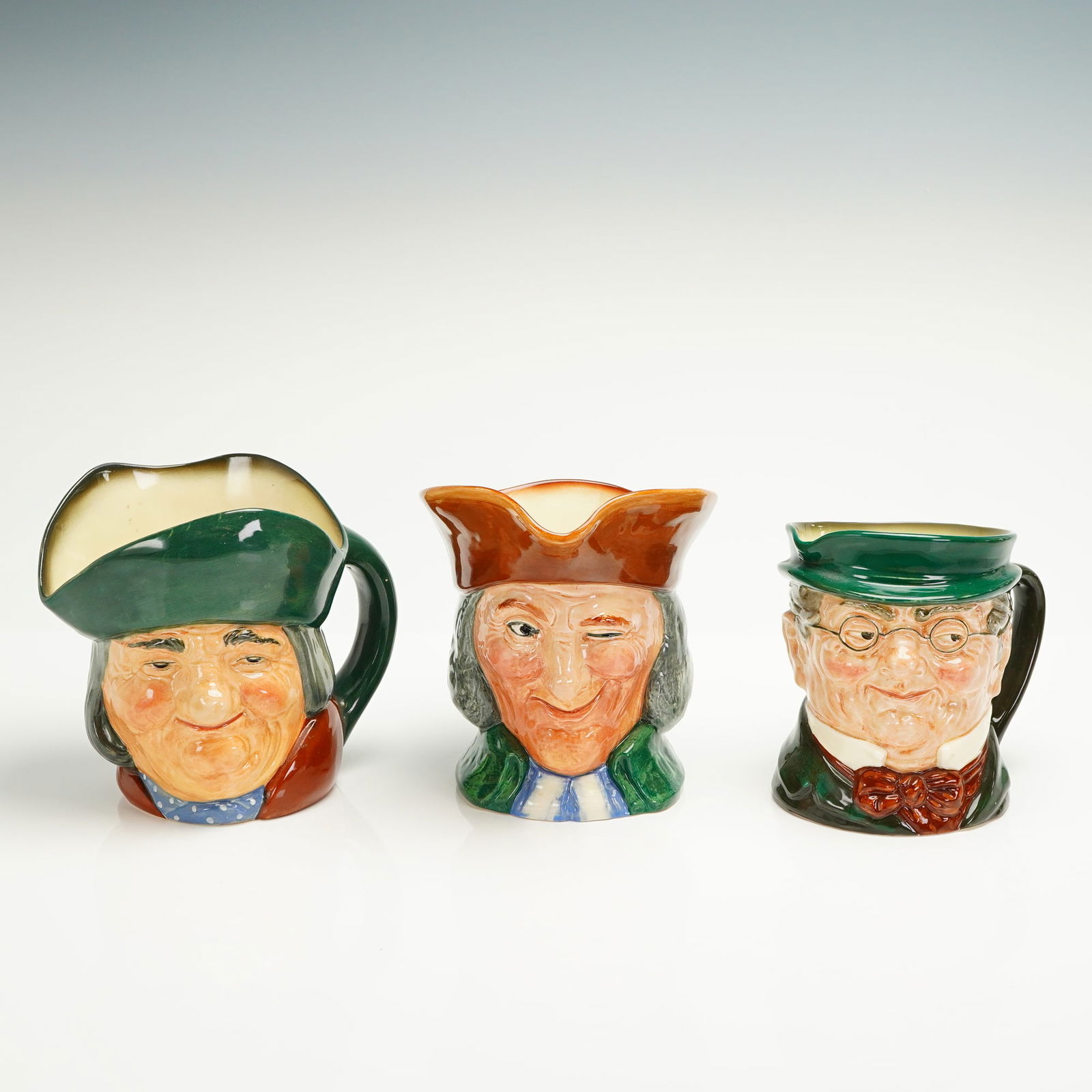 3pc Royal Doulton Large Character Jugs: A collection of three Royal Doulton glazed ceramic character Toby jugs depicting distinct male figures from literature and history. The set includes Mr. Pickwick (D6060), Toby Philpots (D5736), and th