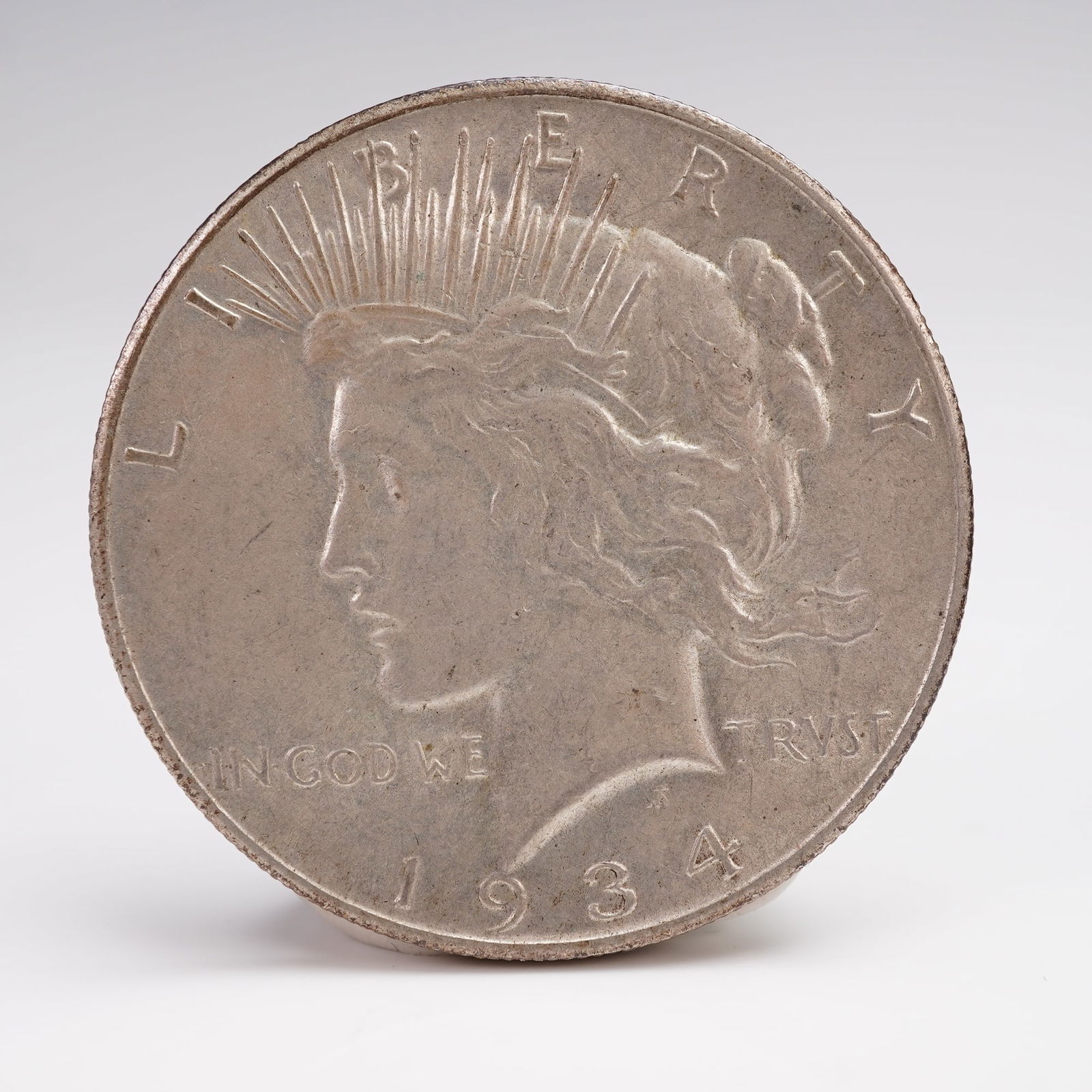 1924 Peace Dollar Silver Coin San Francisco Mint: The 1924 Peace Dollar is struck in .900 fine silver. The obverse features a capped head of Liberty facing left, with a headband adorned with rays. The Latin inscriptions read LIBERTY, IN GOD WE TRVST,
