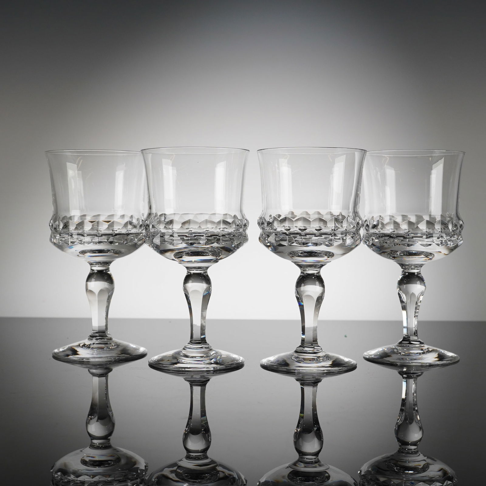 4 Orrefors Silvia Crystal Claret Wine Glasses: A collection of eight Orrefors Crystal glasses in the Silvia patern, designed by Ingeborg Lundin. These stemmed drinking glasses are executed in clear crystal, consistent with high-quality cut glass p