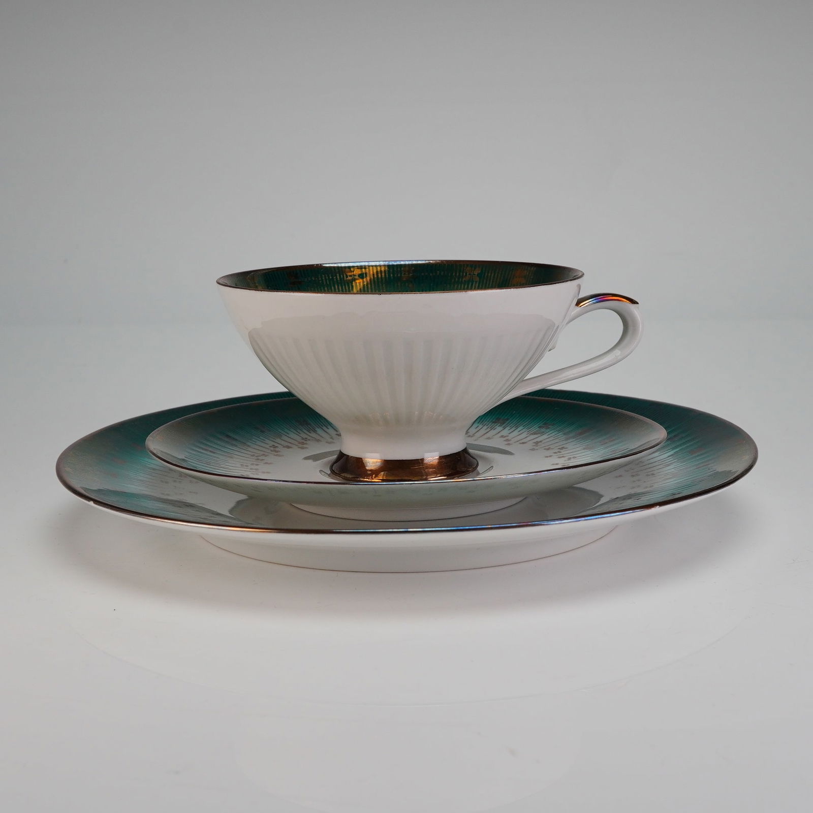 Bareuther Waldsassen Bavaria Trio Tea Set, Emerald Gold: This trio set is decorated in a striking Mid-Century Modern style. The white porcelain body is adorned with a lustrous, iridescent emerald, green band overlaid with an intricate radial gold starburst