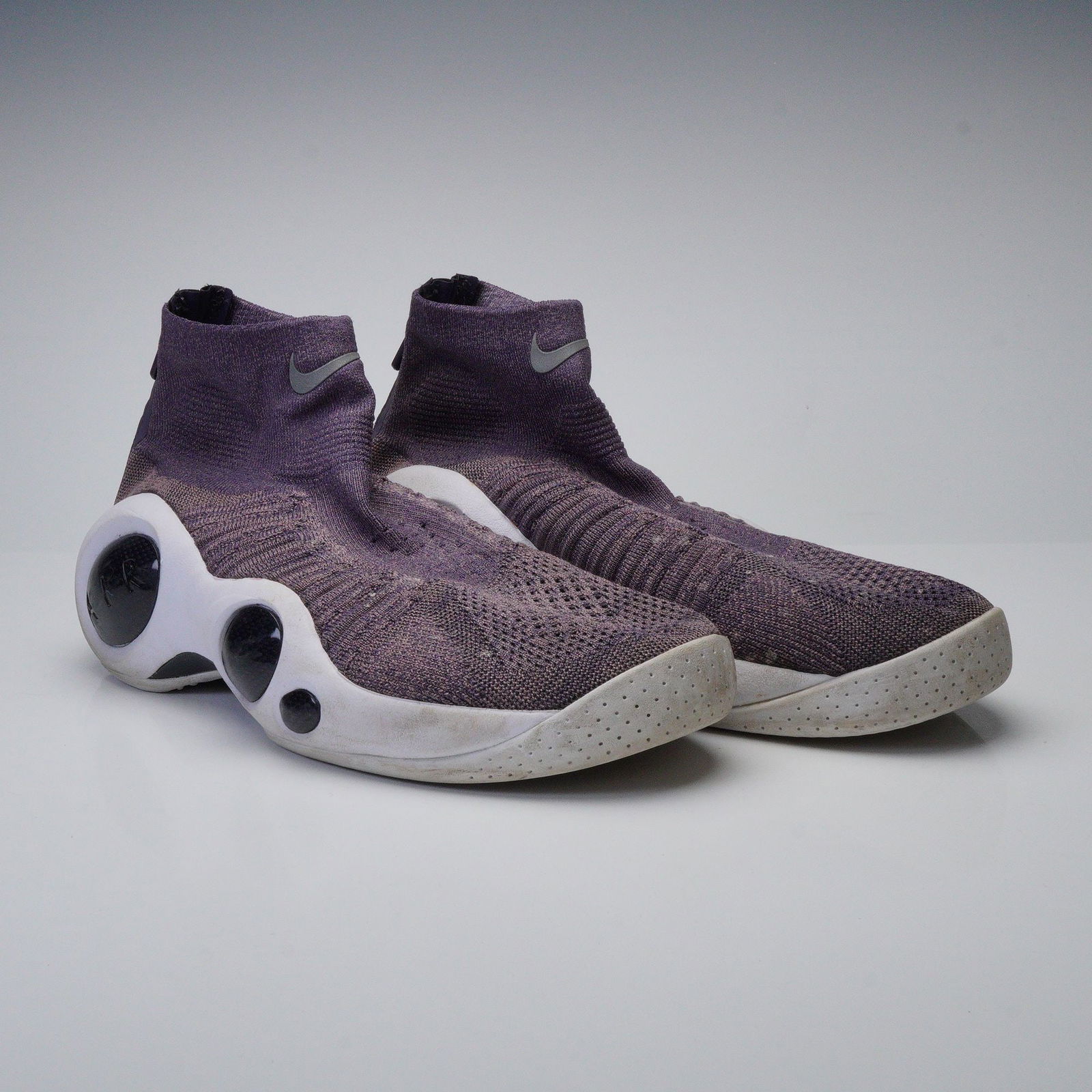 A Pair of Nike Flight Bonafide Plum Sneakers, Style Code 917742-200: A pair of Nike Flight Bonafide Plum athletic shoes, style code 917742-200, originally released circa 2017. These modern high-top athletic shoes feature a predominantly purple knitted textile upper