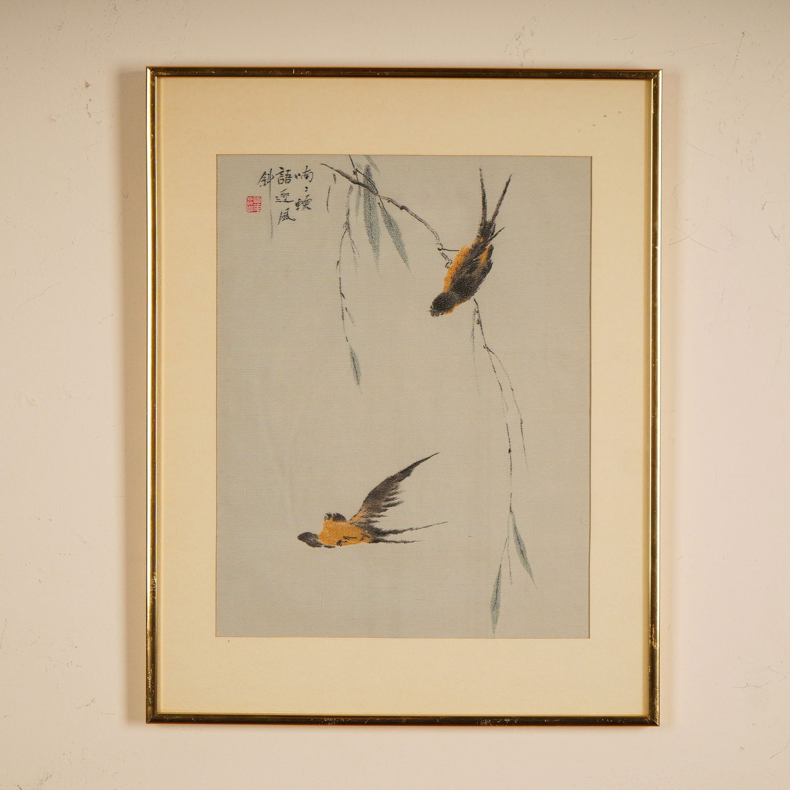 Chinese Textile Art after Qing Dynasty Painter Hua Yan, Swallows in Flight: A refined Asian textile artwork depicting two swallows in flight and repose among slender willow branches. The golden and black plumage of the birds is rendered with graceful economy, creating a