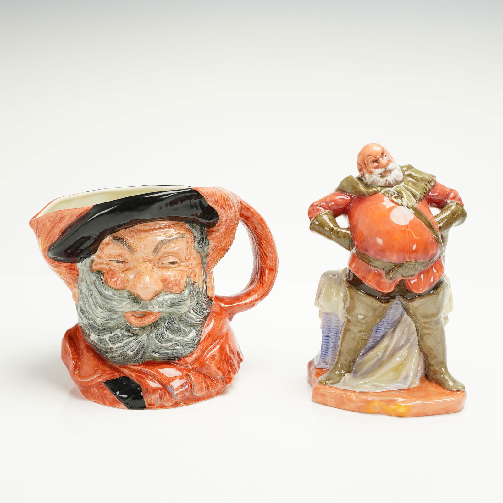 2pc Royal Doulton Large Character Jug and Figurine, Falstaff: Two polychrome glazed porcelain pieces by Royal Doulton depicting the Shakespearean character Sir John Falstaff, comprising a large character jug (D6287) modeled in a rose-red tunic with black hat, ro