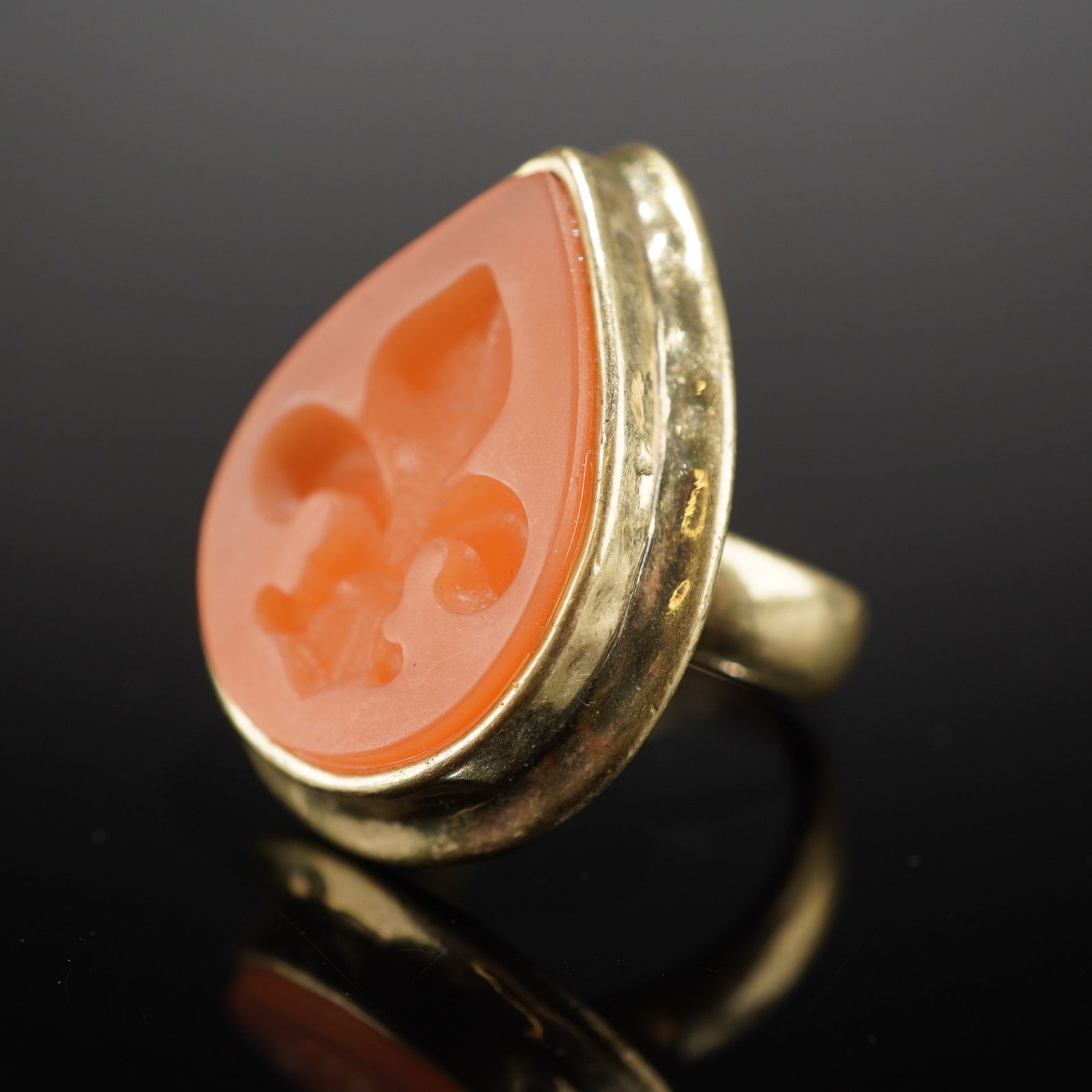 Silpada K&R Collection Fleur de Lis Brass & Resin Statement Ring: Featuring a large, teardrop-shaped bezel setting. The carving depicts the heraldic symbol of a Fleur-de-lis. The reverse of the bezel setting is stamped with the letters "CN" and a second maker's mark