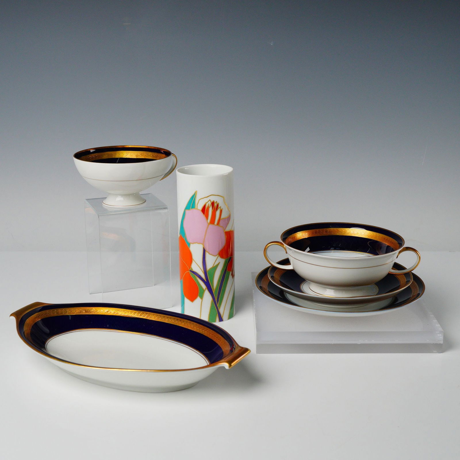 Collection of Six Rosenthal Porcelain Pieces with Cobalt Gilt Tableware: The collection consists of six pieces of Rosenthal porcelain spanning two distinct decorative styles. Six pieces feature a traditional Neoclassical-style decoration characterized by a white ground