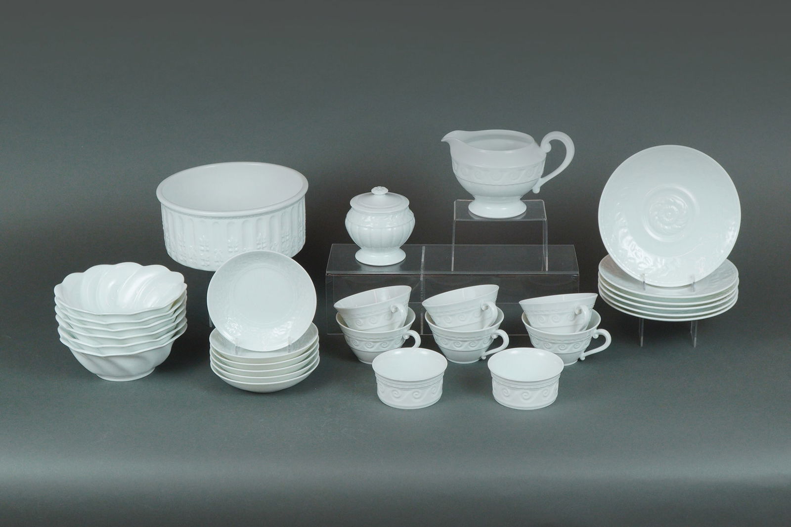 29pc Bernardaud Limoges Porcelain Dinnerware, Louvre: A Collection of 29 pieces of Bernardaud Louvre Porcelain Kitchenware, including 6 teacups, 6 saucers, 6 bread plates, 6 flower bowls, 2 ramekins, 1 creamer, 1 sugar jar, and 1 serving bowl, all featur