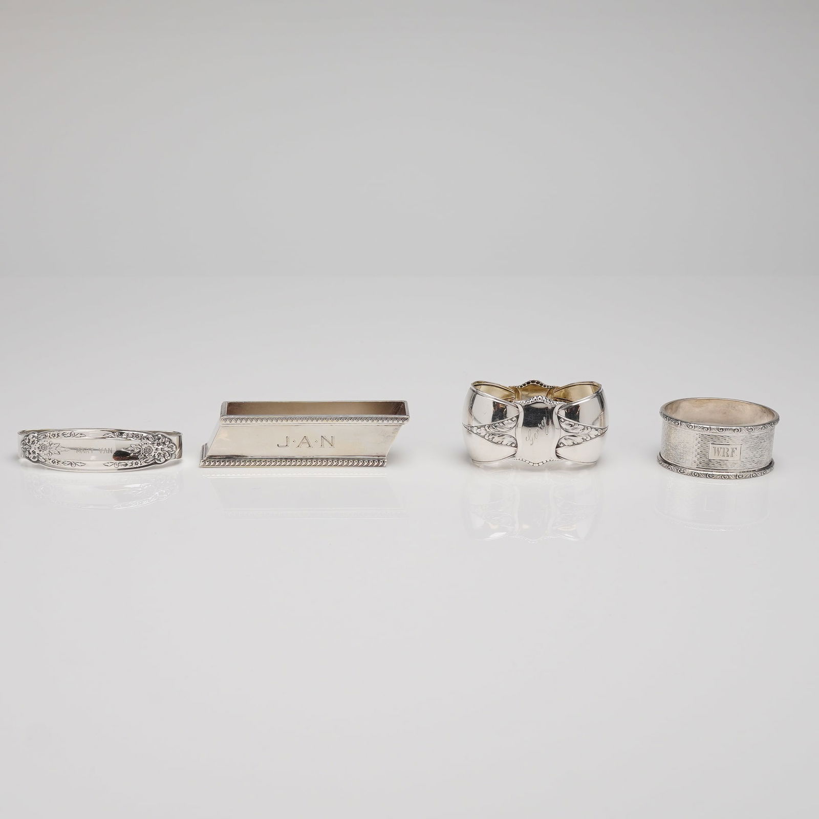A Collection of Four Sterling and 800 Standard Silver Napkin Ring Holder (1 of 5)