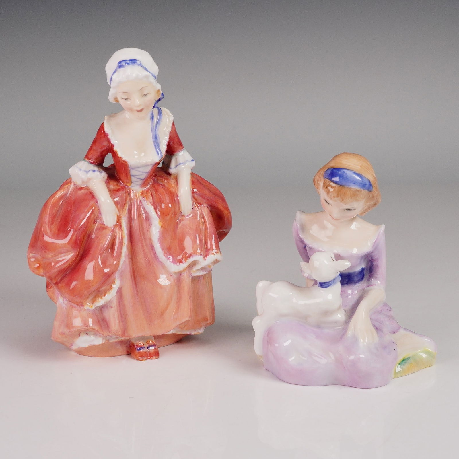 2pc Royal Doulton Figurine Mary Had A Little Lamb HN2048 and Goody Two Shoe: This enchanting 2-piece Royal Doulton figurine grouping features Mary Had A Little Lamb HN2048 and Goody Two Shoes HN2037, 1905. Mary Had A Little Lamb, designed by Peggy Davies, is part of the