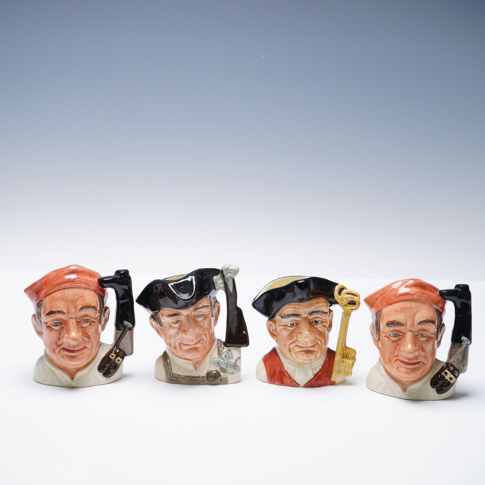 4pc Royal Doulton Williamsburg Character Jugs: Set of four Royal Doulton character jugs from the Williamsburg Series, including two Bootmaker jugs D6579, one Gaoler jug D6577, and one Gunsmith jug D6580. Each jug is hand painted and carries the Ro