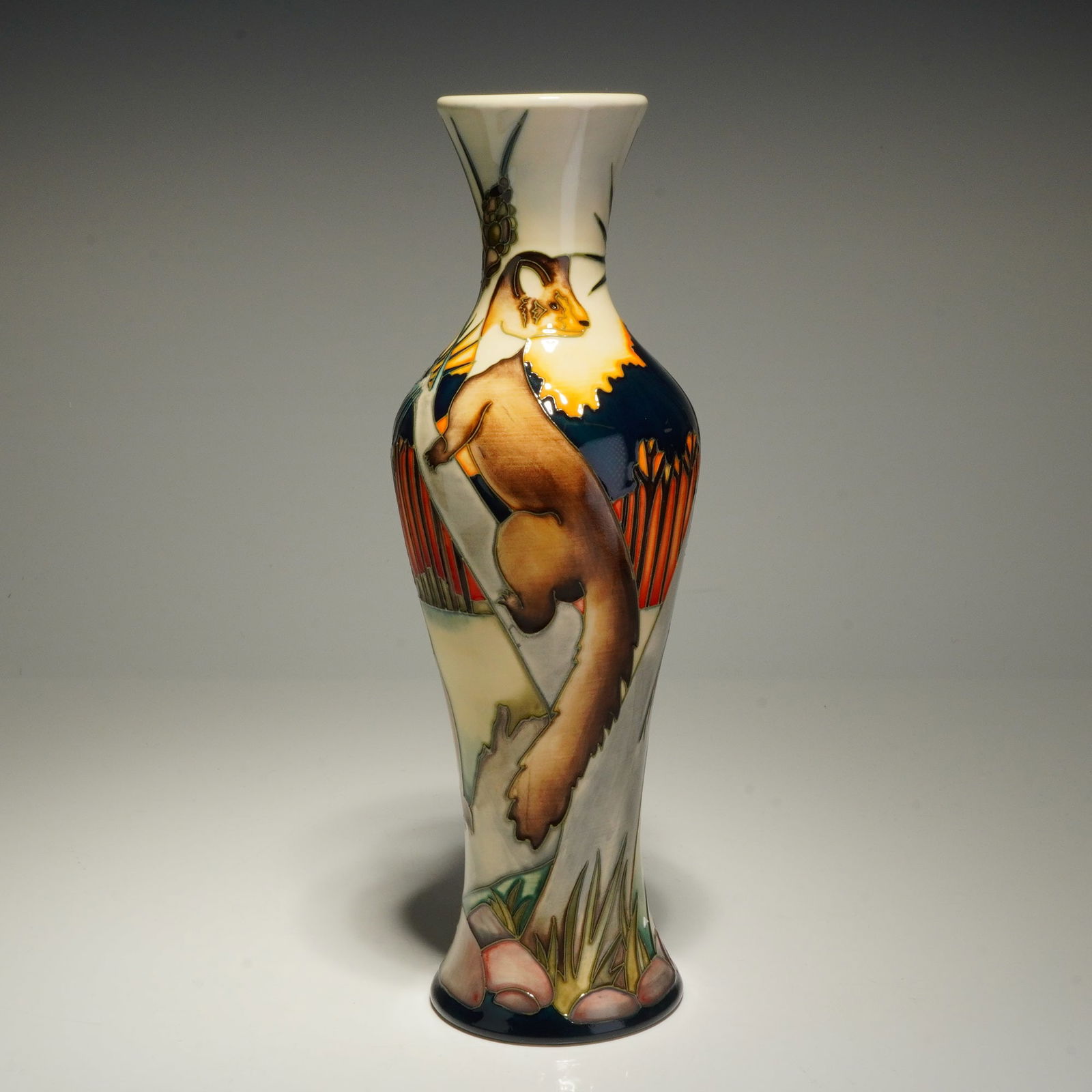Moorcroft Pine Marten Vase by Kerry Goodwin, Signed: This Moorcroft ceramic vase is decorated in the Pine Marten pattern, designed by Kerry Goodwin. The vessel features a tall, slender, waisted form with a flared rim and base, identified as shape 93/10.
