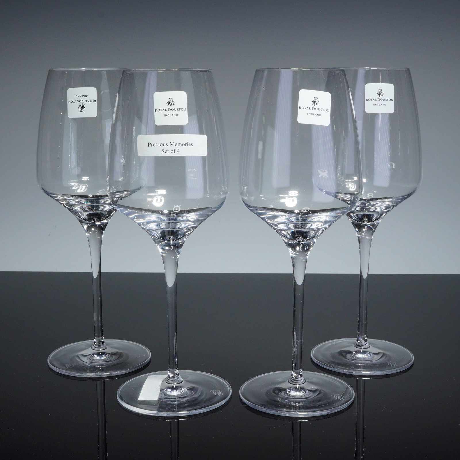 4pc Royal Doulton Crystal White Wine Glasses: This set of 4 Royal Doulton white wine glasses is part of The Wine Cellar Collection, with manufacturer labels further identifying the pattern as Precious Memories. Each glass is composed of clear cry