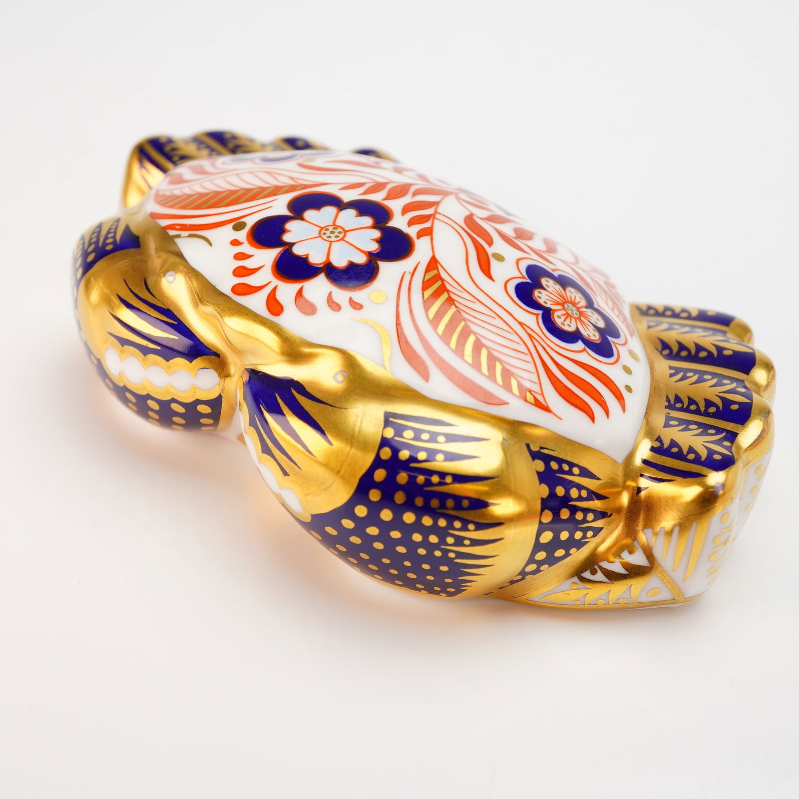 Royal Crown Derby Crab Paperweight with Box: This Royal Crown Derby paperweight is modeled in the form of a crab and decorated in the traditional Imari pattern. The piece is constructed of fine bone china and features a palette of cobalt blue an