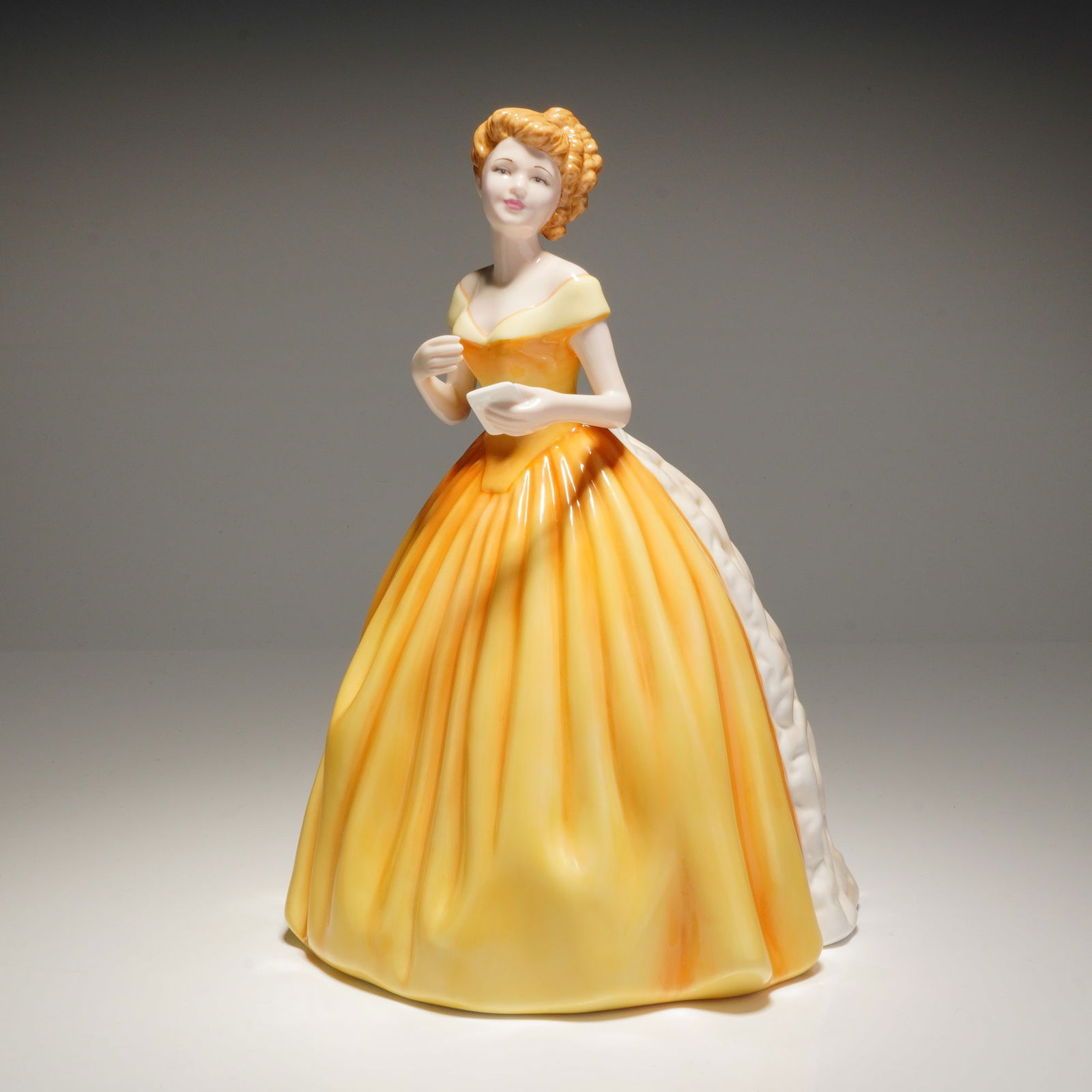 Royal Doulton Pretty Ladies Figurine Sweet Rose HN4731: A Royal Doulton bone china figurine titled Sweet Rose HN4731, modeled by M. Davies in 2005, depicting a woman in a yellow and white gown holding a note reading "With Love," marked "ROYAL DOULTON PRETT