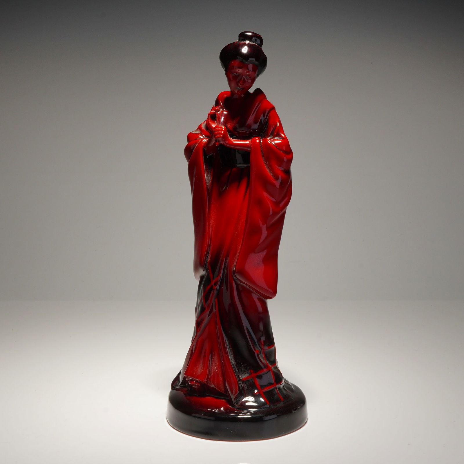 Royal Doulton Flambe Porcelain Figurine, The Geisha HN3229: Royal Doulton Flambe porcelain figurine titled The Geisha HN 3229. This model was sculpted by Pauline Parsons and released in 1989 as an exclusive for the Royal Doulton International Collectors Club.