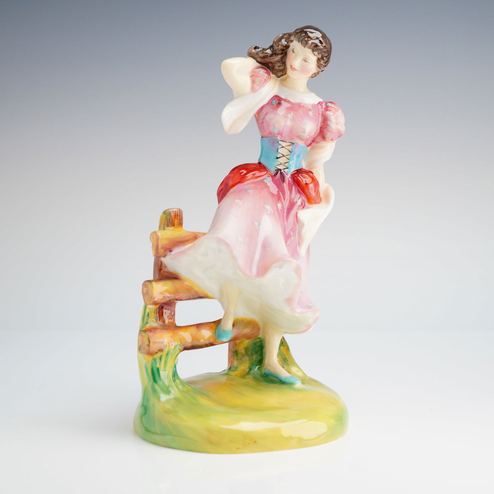 Royal Doulton Figurine, Summer HN2086: A Royal Doulton figurine, depicting a woman in a pink and red dress standing by a fence, marked on the underside COPR.1951 along with Royal Doulton backstamp. Dimensions: 4.00"L x 7.50"H Weight: 13.00