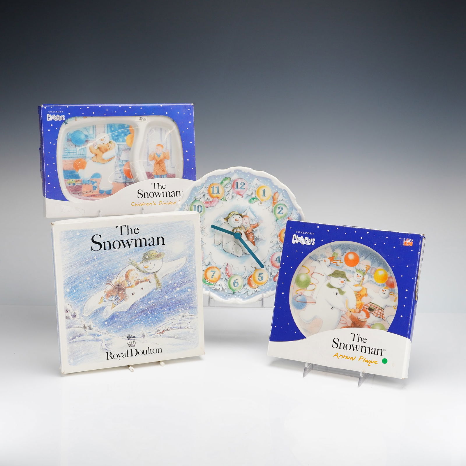 4pc Coalport Characters The Snowman Giftware: A 4pc collection of Coalport Characters The Snowman giftware featuring ceramic items inspired by the characters created by Raymond Briggs. The group includes a children's divided plate and an annual p