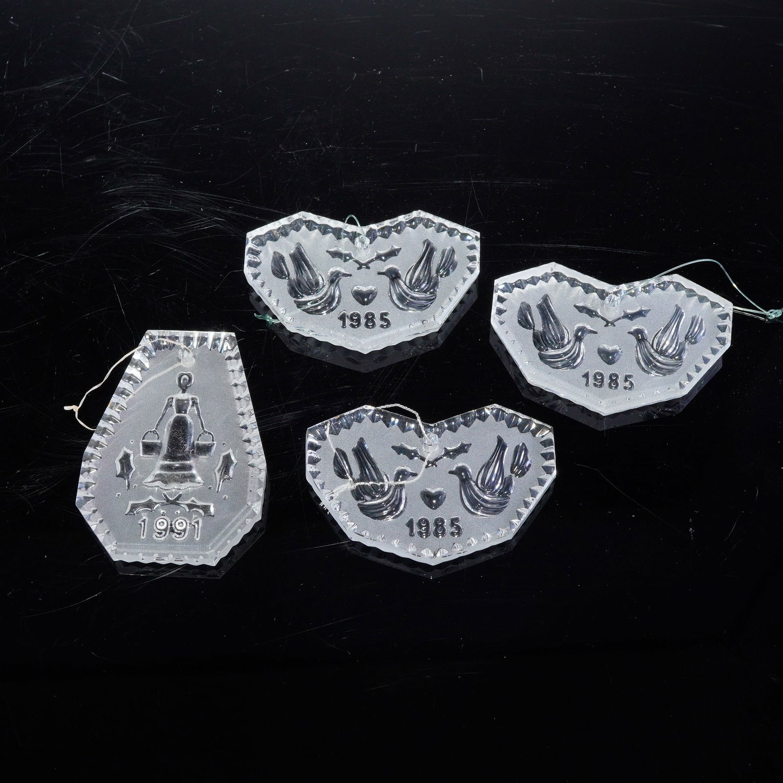 4pc Waterford Crystal Annual Holiday Ornaments, 1985 & 1991: Collection including three 1985 ornaments and one 1991 ornament. Each piece showcases Waterford's signature brilliance and finely cut detail, making them ideal additions for collectors of early annual