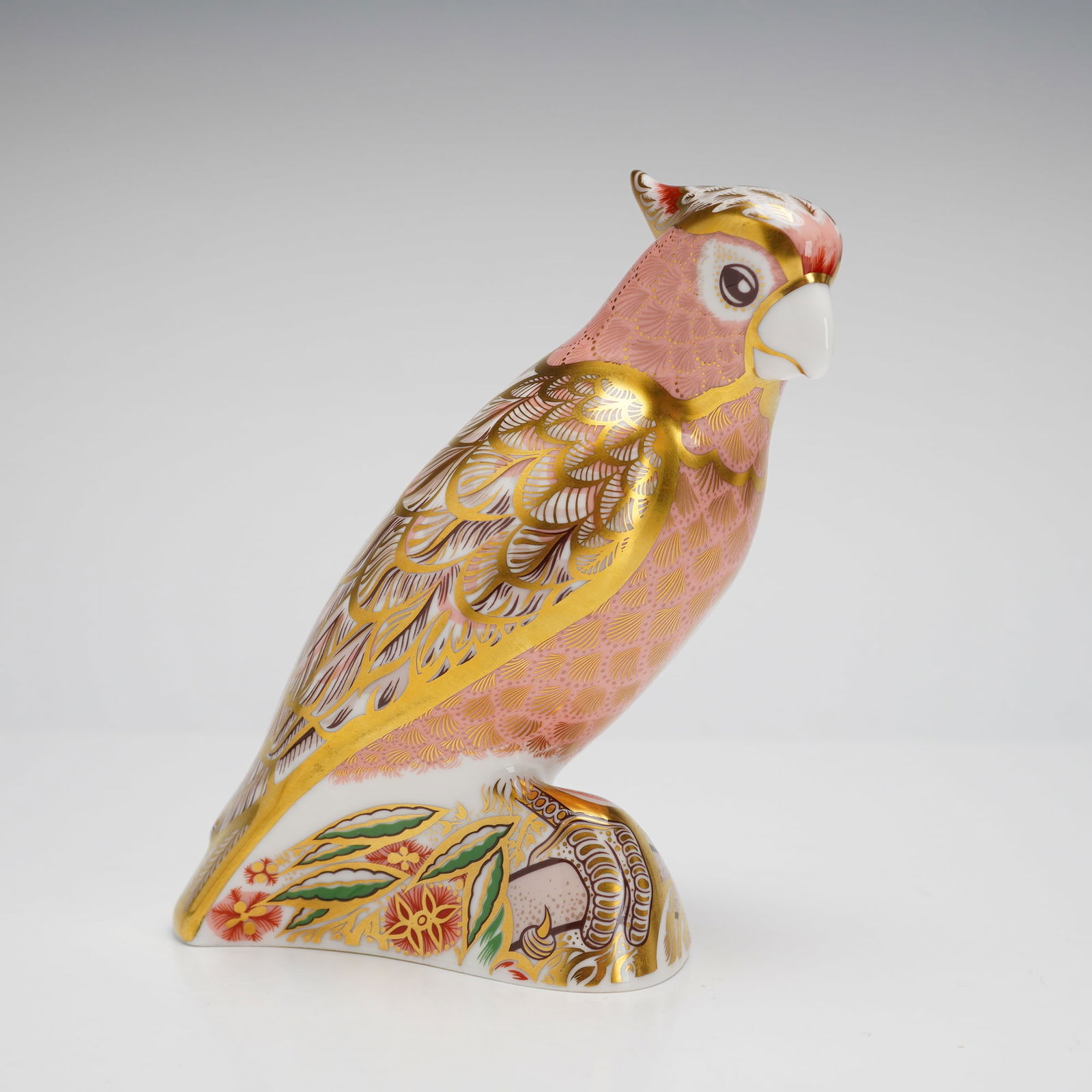 Limited Edition Royal Crown Derby Pink Cockatoo Paperweight: Royal Crown Derby English bone china paperweight depicting a cockatoo, part of a specially commissioned limited edition. The piece features an Imari-style design with a pink feathered pattern and gold
