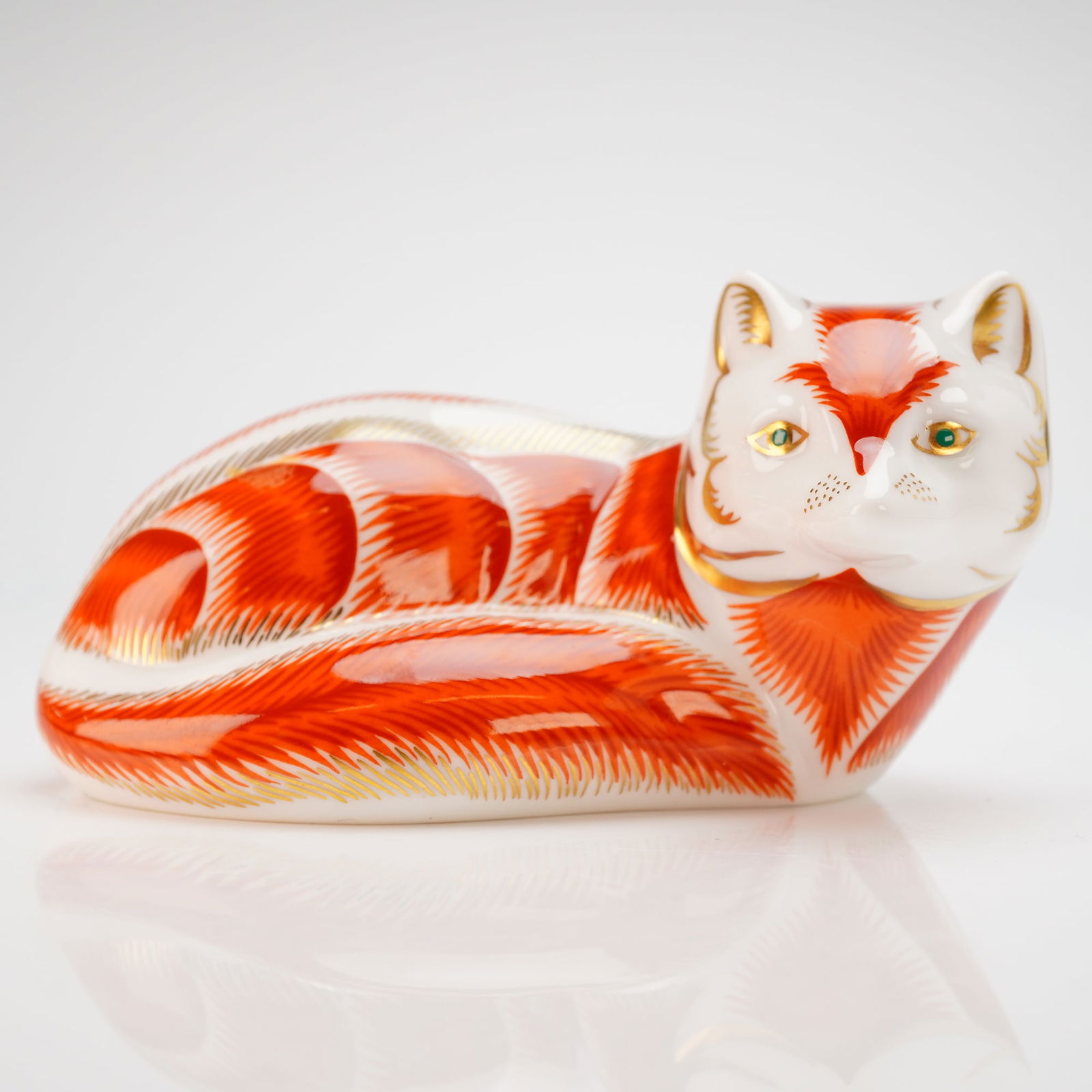 Royal Crown Derby Imari Paperweight Collection Red Fox with Box: A Royal Crown Derby fine bone china paperweight from the Imari collection depicting a reclining red fox. The figurine is decorated with orange-red feathered patterns and 22-karat gold gilding on a whi