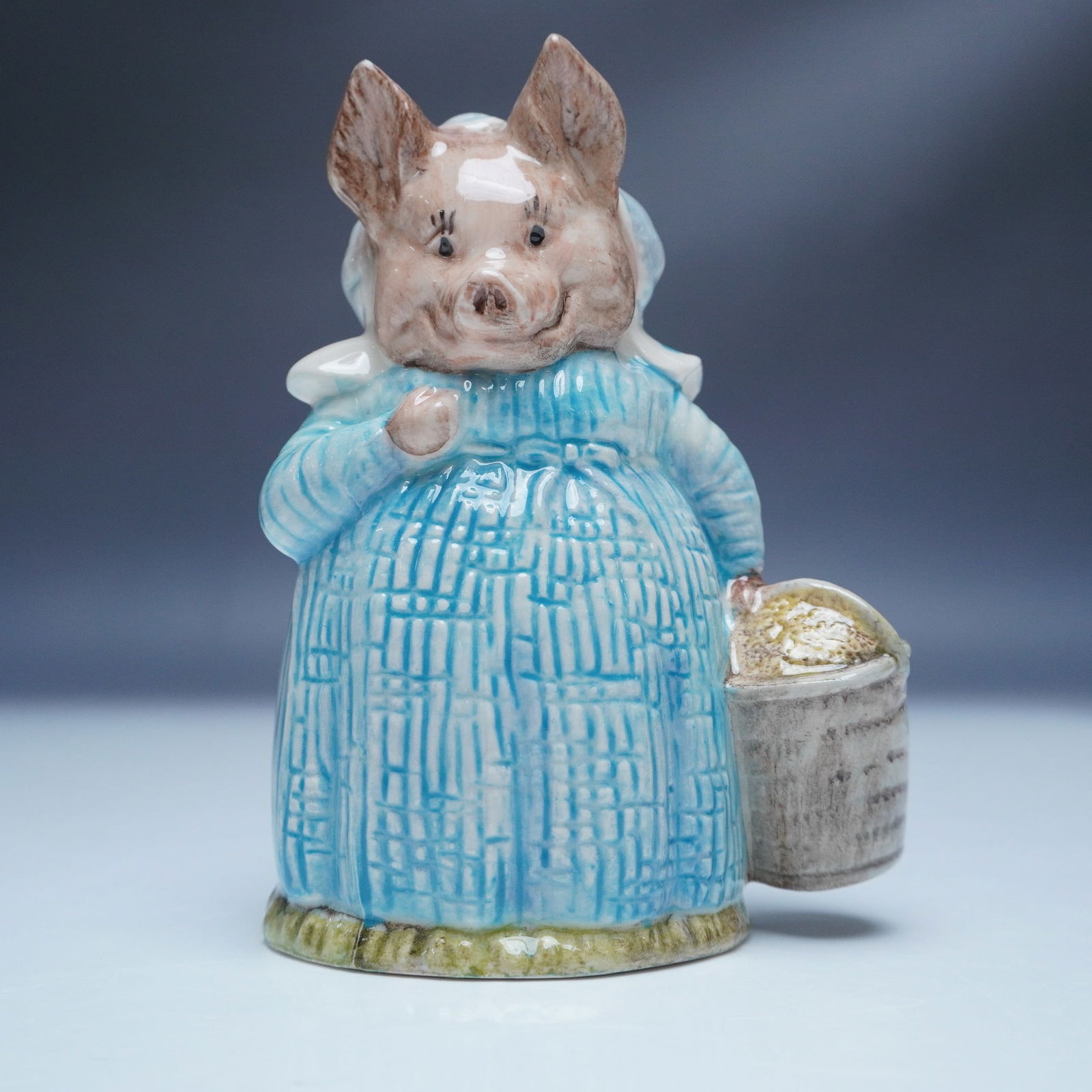 Beatrix Potter Aunt Pettitoes Figurine by Royal Albert: This Royal Albert figurine of Aunt Pettitoes brings to life one of Beatrix Potter's classic characters. Crafted from fine bone china, the hand-painted details include her signature blue dress and buck
