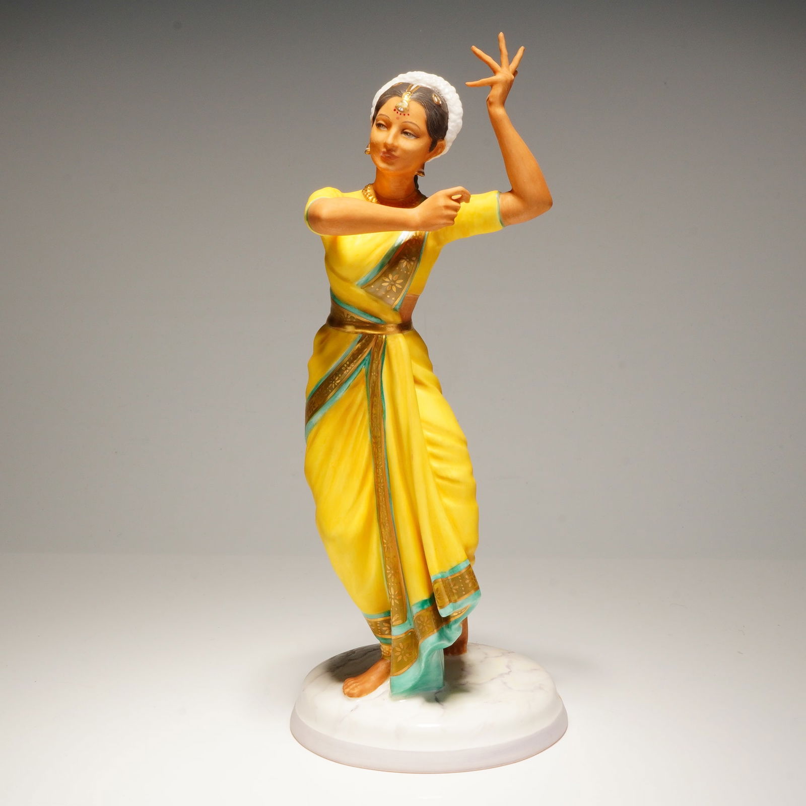 Royal Doulton Dancers of the World Figurine, Indian Temple Dancer HN2830: This Royal Doulton bone china figurine, titled Indian Temple Dancer (HN2830), is part of the Dancers of the World series and was modeled by artist Peggy Davies. Produced in 1976, the hand-painted figu