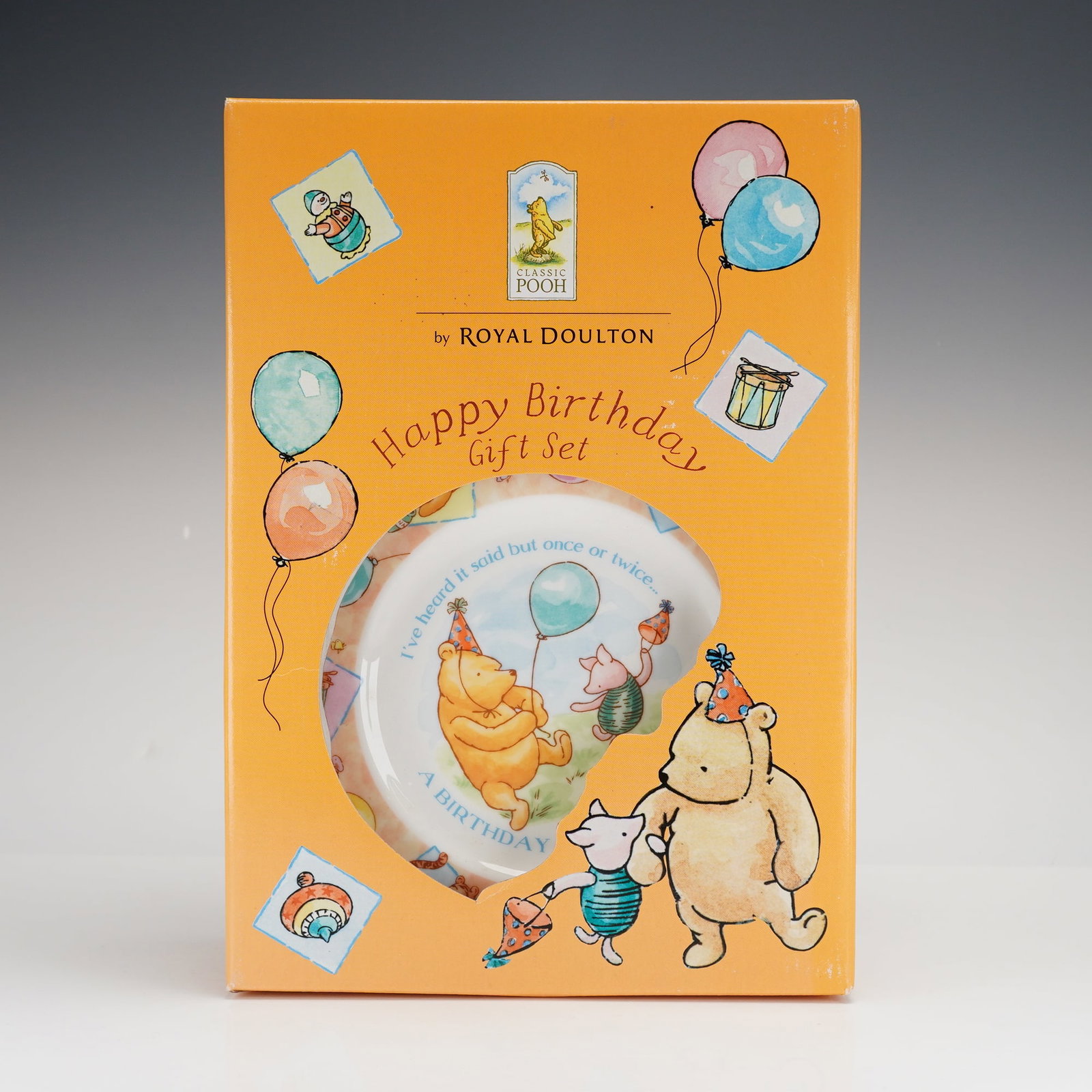 3pc Royal Doulton Classic Pooh Happy Birthday Gift Set: A Royal Doulton Classic Pooh Happy Birthday 3pc gift set, comprising a plate, bowl, and cup. This fine china collection features illustrations based on the Winnie-the-Pooh stories by A.A. Milne and th