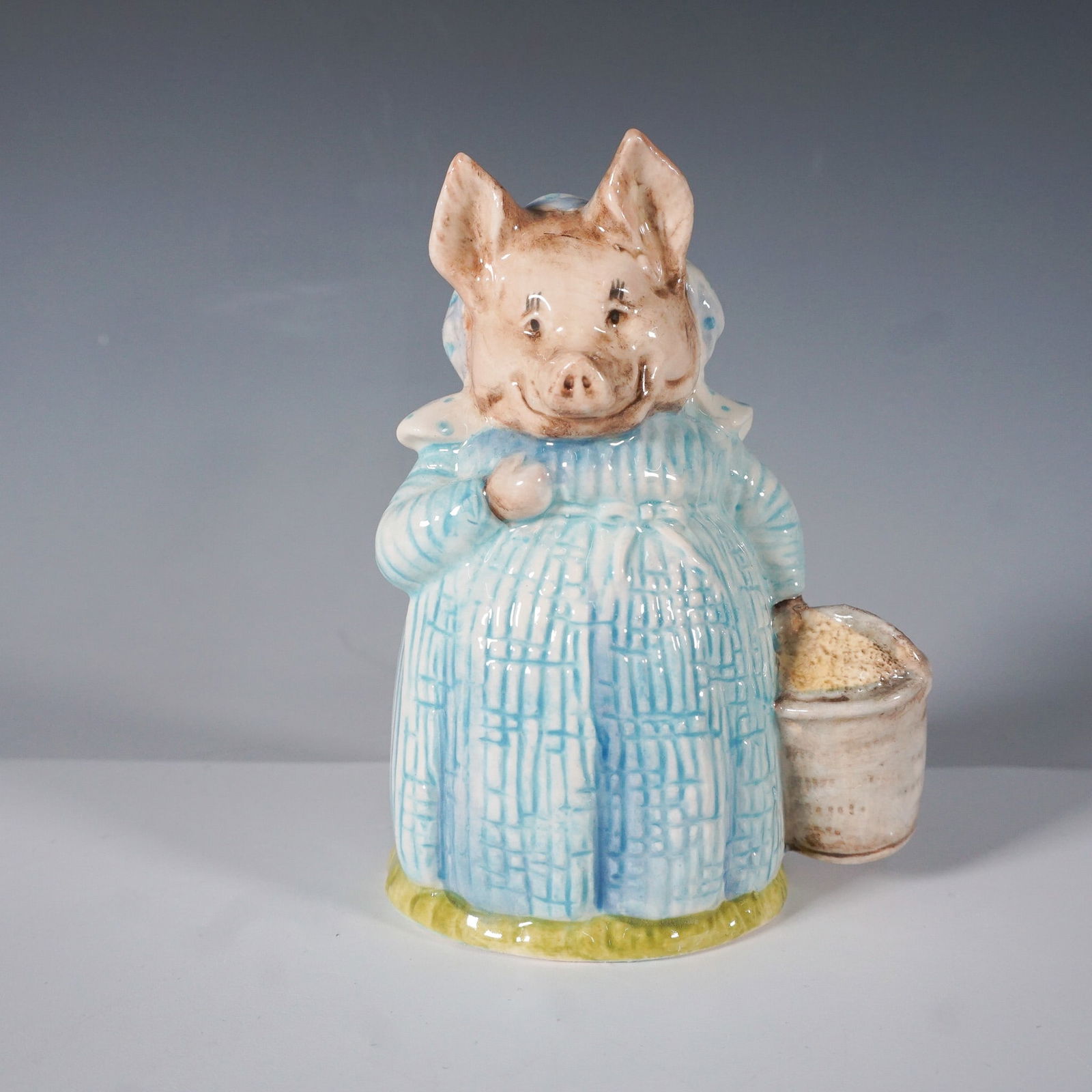 Royal Albert Beatrix Potter "Aunt Pettitoes" Figurine: From The World of Beatrix Potter collection, this Aunt Pettitoes figurine was produced by Royal Albert in 1989. Hand-painted and made of fine china, it depicts Aunt Pettitoes in her signature blue dre
