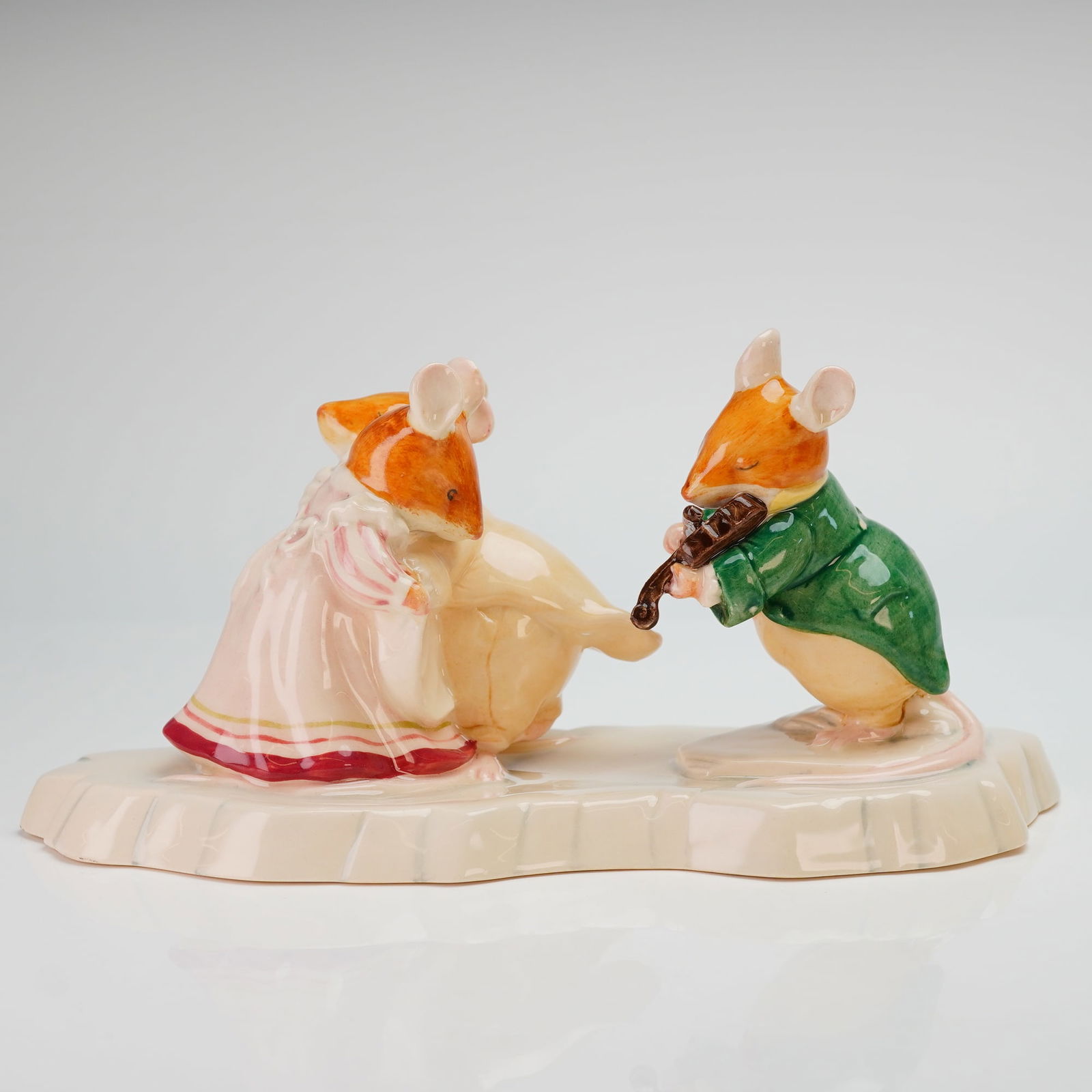 Royal Doulton Brambly Hedge Figurine, The Ice Ball DBH30: This Royal Doulton porcelain figurine is a hand-made and hand-decorated piece from the Brambly Hedge collection. The figurine depicts a group of anthropomorphic mice upon a base modeled to resemble a