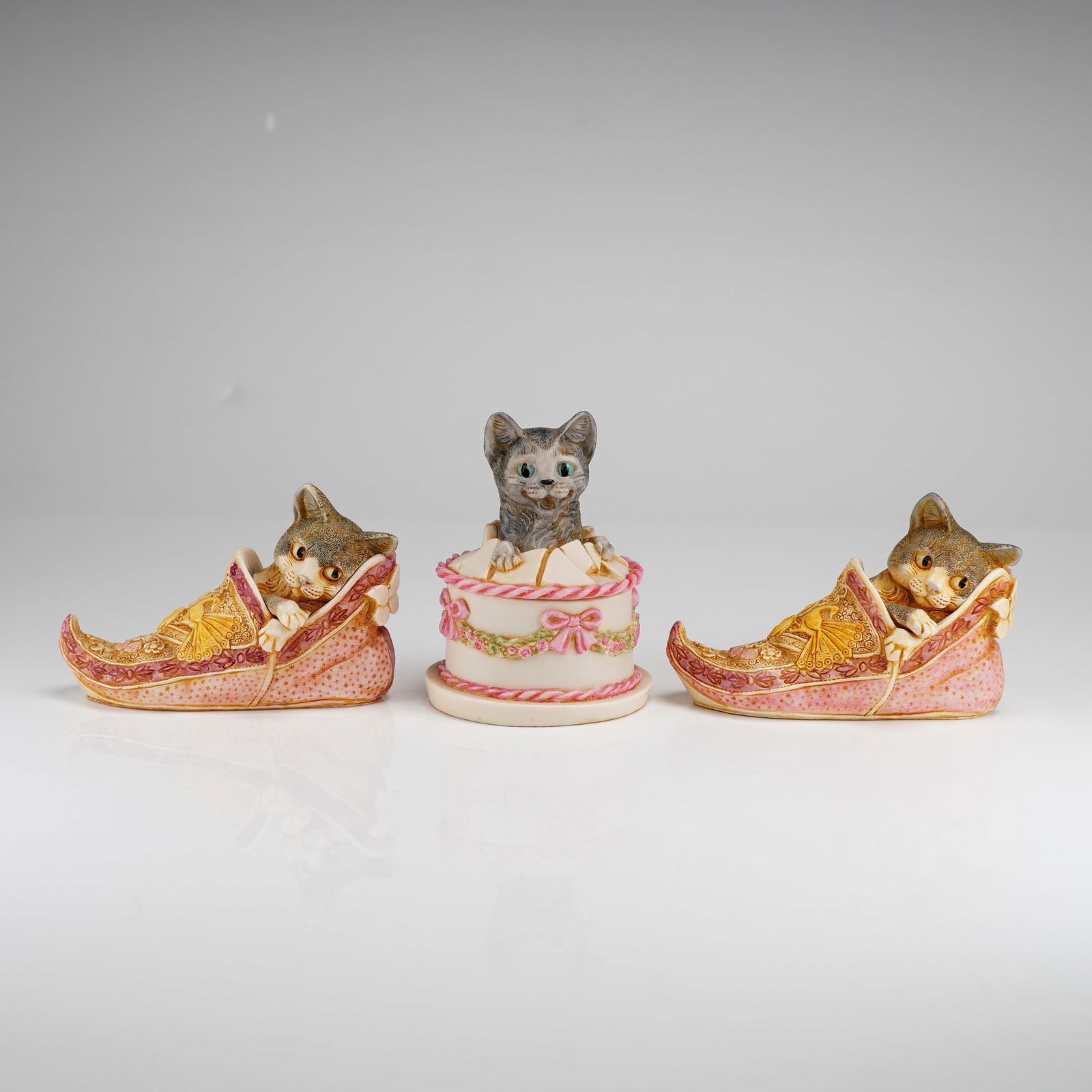 3pc Harmony Kingdom Box Figurines, Gateau & Sharazade: The Gateau box features a kitten emerging from a decorated cake with pink bows and floral garlands. The two Sharazade boxes depict kittens nestled within pointed, decorated pink slippers featuring but