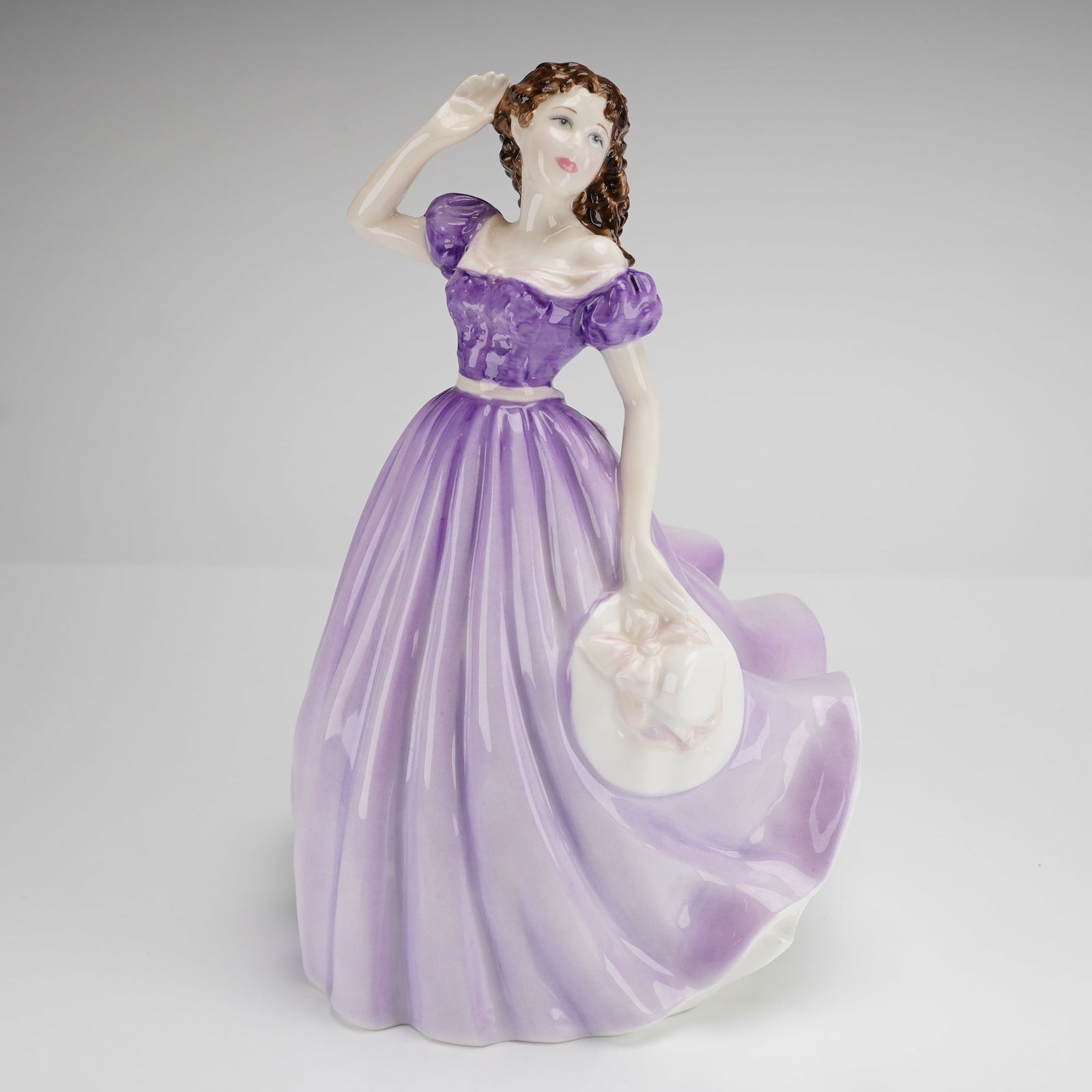 Royal Doulton Bone China Figurine Bells Across the Valley HN4300: A Royal Doulton bone china figurine titled Bells Across the Valley (HN4300), modeled by Nada M. Pedley. The piece is hand-made and hand-decorated in England, depicting a woman in a flowing purple and
