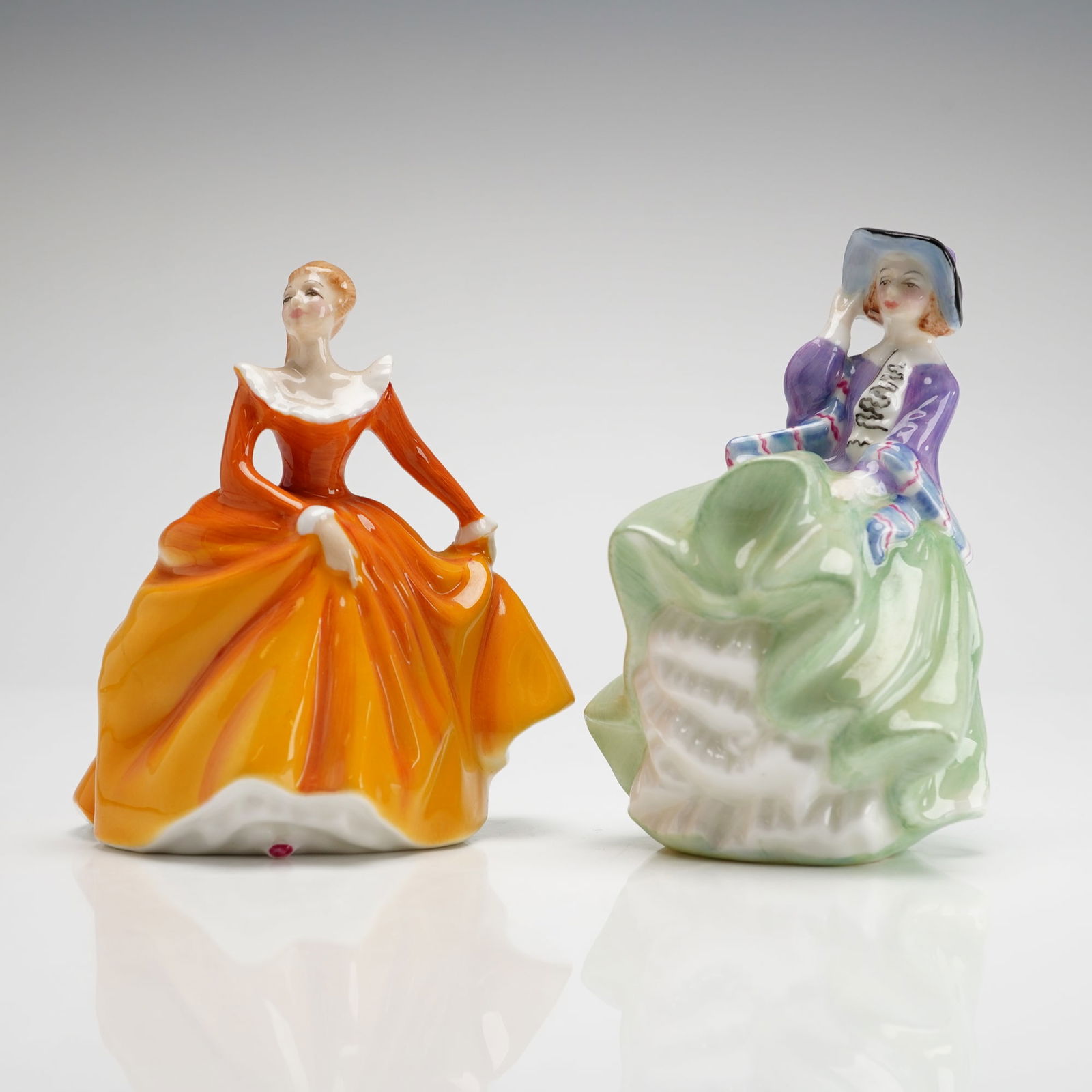 Two Royal Doulton Mini Figurines Top O' The Hill HN2126 & Fragrance HN3220: The Fragrance figurine, designed by Peggy Davies, is depicted in a hand-painted orange and yellow layered gown with a white collar and bears a 1965 copyright date. The Top O' The Hill figurine is show