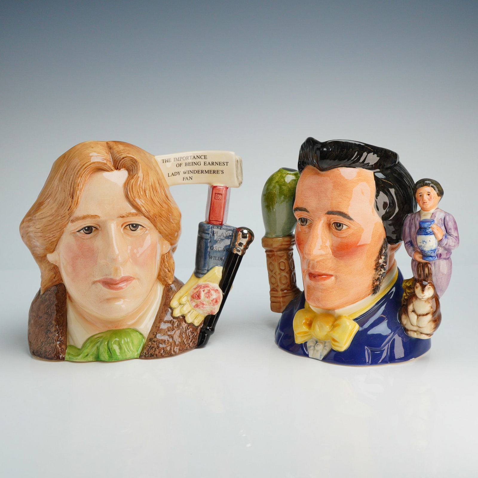 2pc Royal Doulton Character Jugs, Oscar Wilde & Sir Henry Doulton w/ COA: Two Royal Doulton hand-painted glazed ceramic character jugs. The first depicts Oscar Wilde, Character Jug of the Year 2000, model D7146, modeled by David B. Biggs. The handle is designed as a stack o