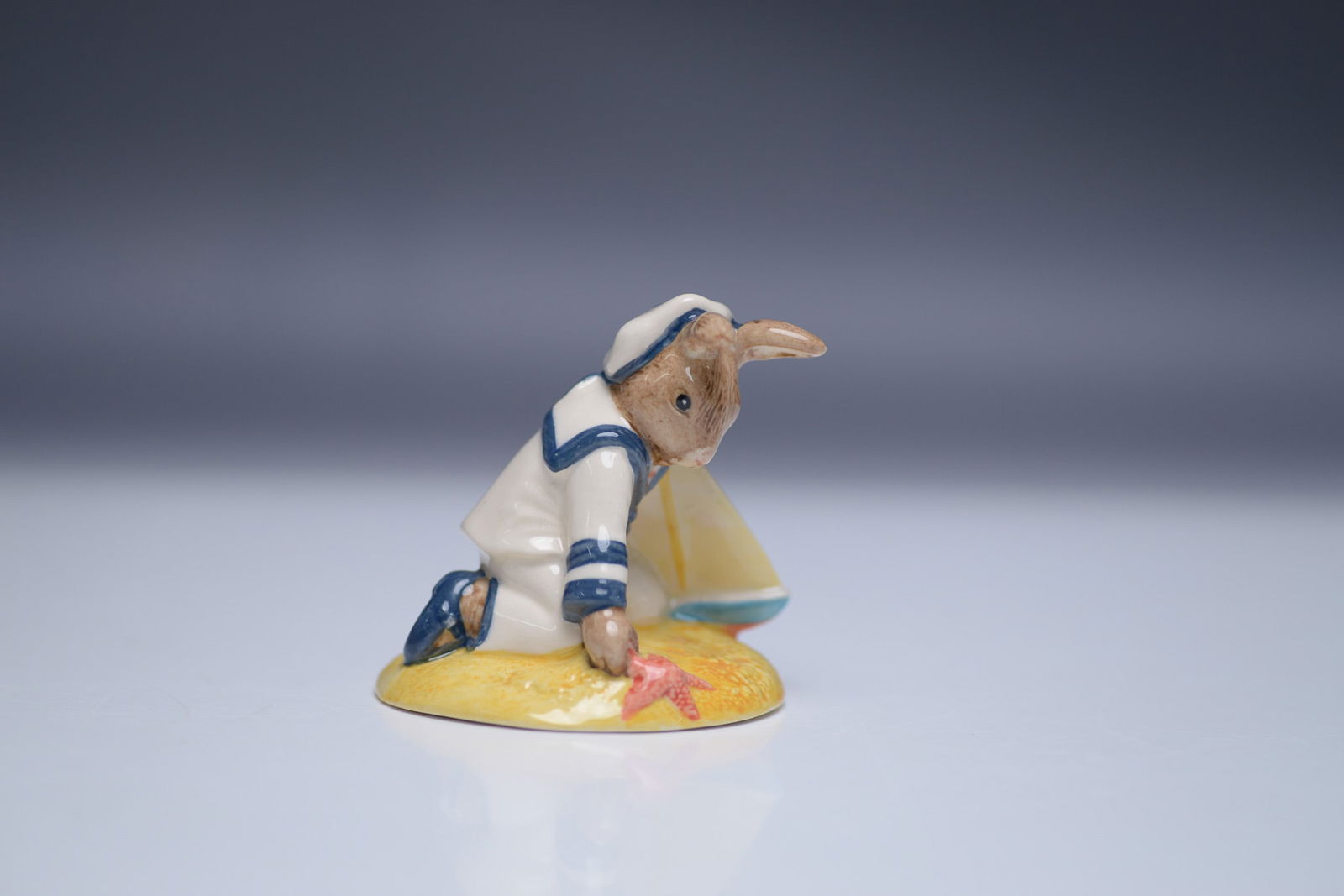 Royal Doulton Bunnykins Figurine, Sailor Bunnykins DB166: Royal Doulton Bunnykins figurine titled "Sailor Bunnykins," model DB166. This piece was introduced as the Bunnykins Figure of the Year in 1997, crafted with fine hand-painted details. Measuring 2.75"H