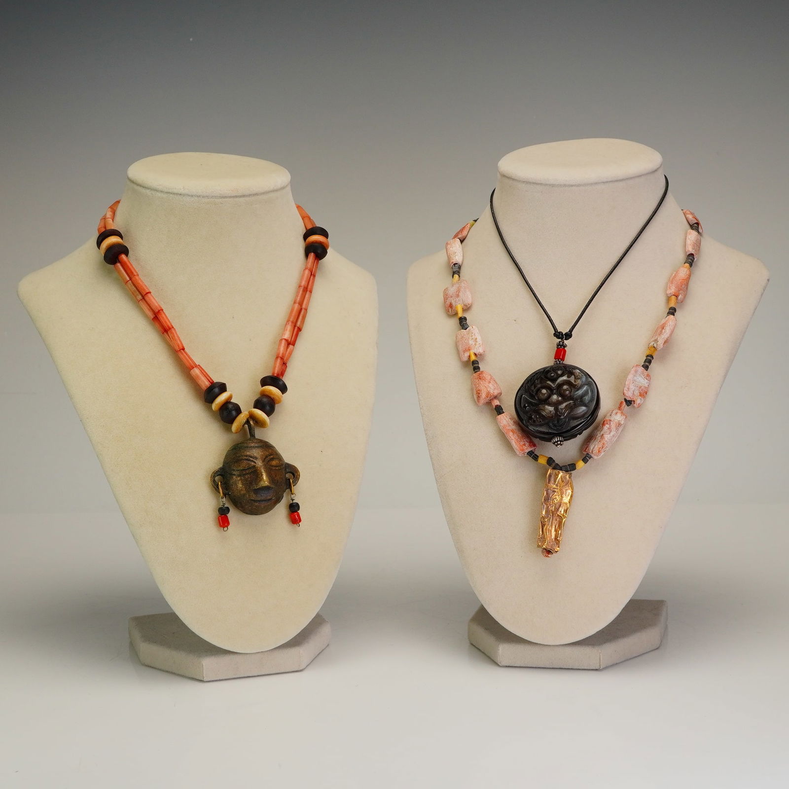 3pc Asian and Tribal Beaded Pendant Necklaces: A collection of three necklaces featuring ethnographic and folk-style designs. The first item is a bronze pendant necklace featuring a cast bronze head with dangling bead accents and a cowrie shell