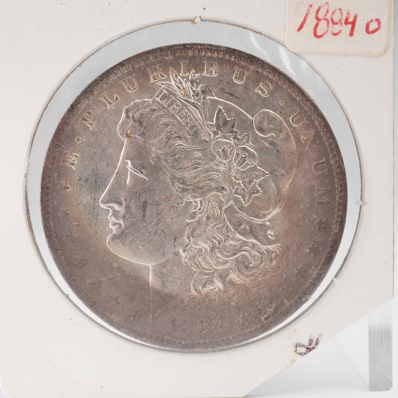 1884-O Morgan Silver Dollar: An 1894-O Morgan Silver Dollar, minted in New Orleans and bearing the hallmark "O" mintmark below the eagle on the reverse. Designed by George T. Morgan, the obverse presents the dignified bust of Lib