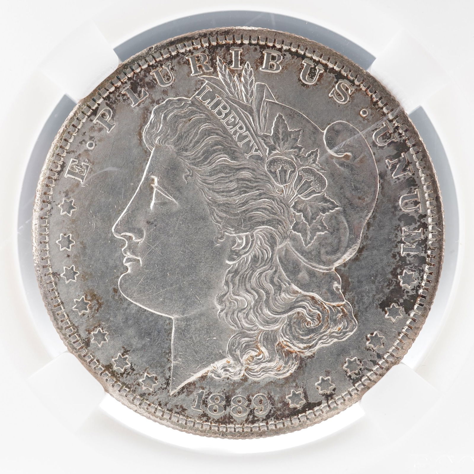 1889-S Morgan Silver Dollar: An 1889 Morgan Silver Dollar struck at the San Francisco Mint, identified by the "S" mint mark on the reverse below the wreath. Designed by George T. Morgan, the obverse depicts Lady Liberty wearing a