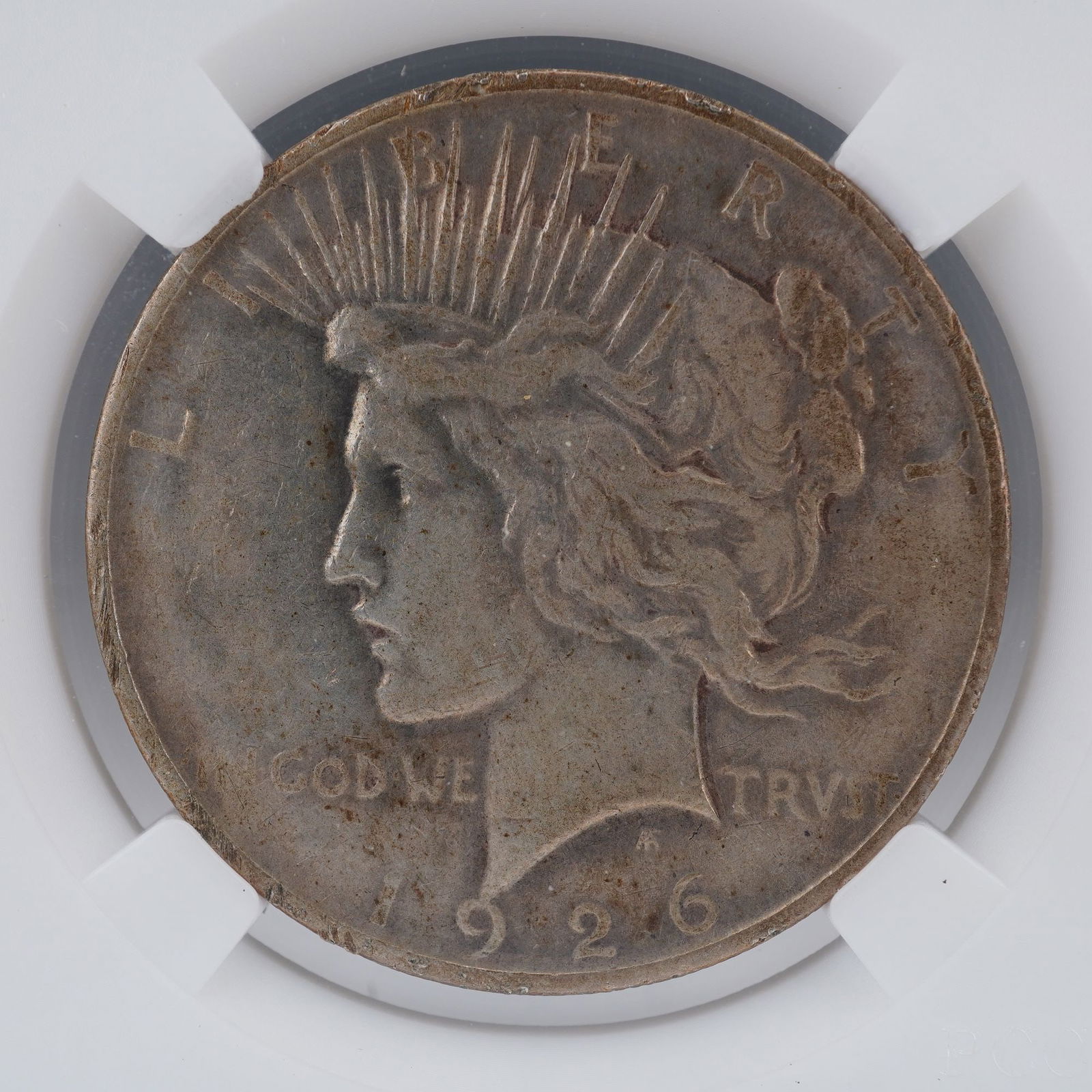 1926-D Peace Silver Dollar: A 1926-D Peace Silver Dollar, struck at the Denver Mint and created by Anthony de Francisci. The obverse displays the dignified profile of Liberty wearing a radiant crown, a motif symbolizing freedom
