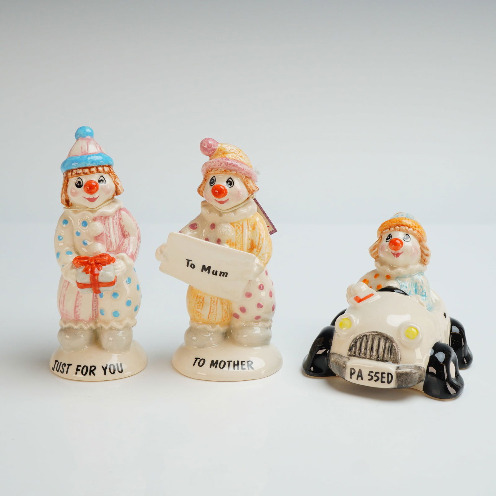 3pc Beswick Little Lovables Figurines, To Mother, Just For You, & Passed: Glazed porcelain clown figurines from the Little Lovables series. The collection includes three distinct models: Just For You (LL 4), featuring a clown holding a gift box with the base inscribed Just