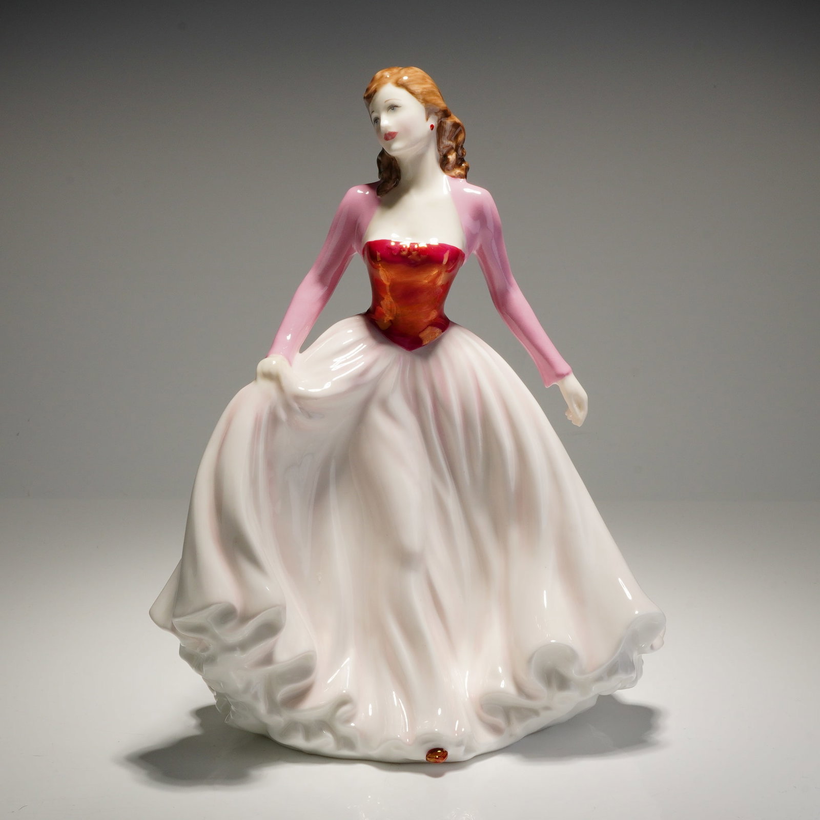 Royal Doulton Happy Anniversary Pink Figurine HN 4606: A Royal Doulton porcelain figurine from the Classics series titled Happy Anniversary Pink, model number HN 4606. This piece was modeled by John Bromley and is dated 2003. The figure depicts a woman wi