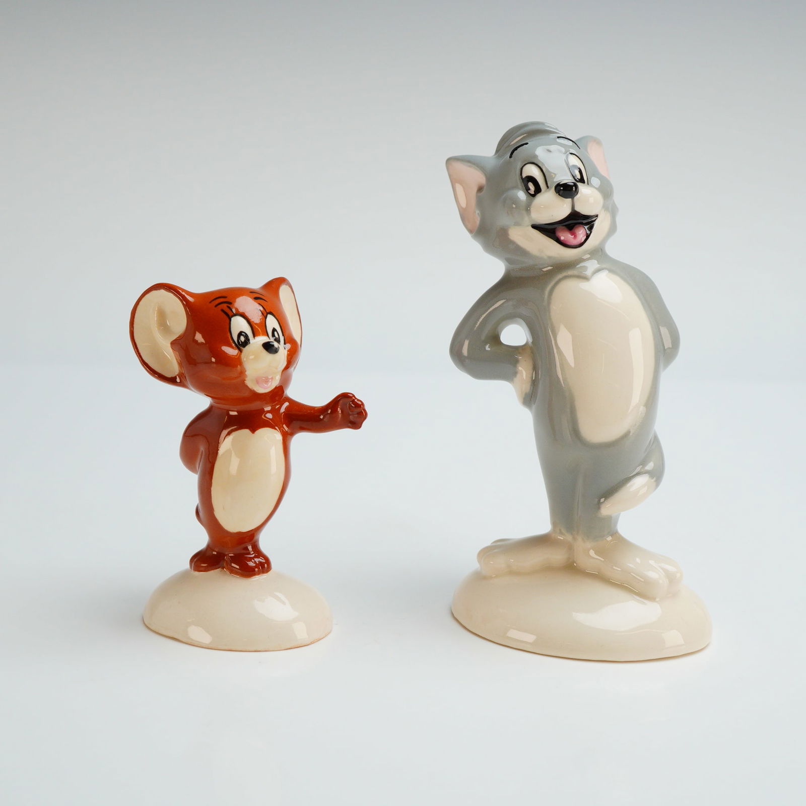 A Pair of Beswick Tom and Jerry Limited Edition Ceramic Figurines: A pair of Beswick ceramic figurines of cartoon characters Tom and Jerry. These models were produced in 1995 as an exclusive worldwide edition limited to 2,000 sets. The figures are crafted from potter