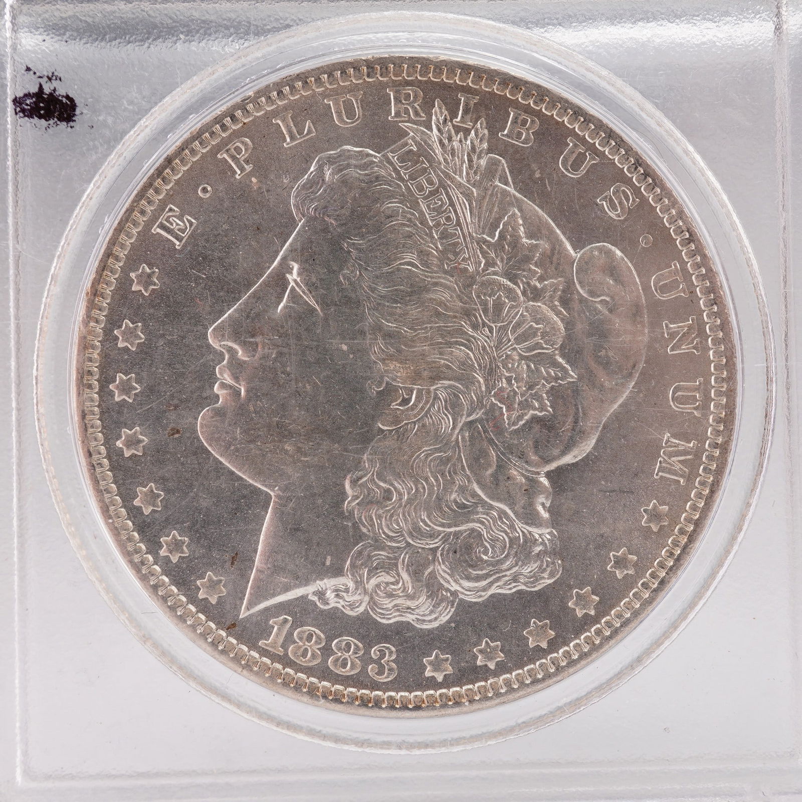 1883 Morgan Silver Dollar: This 1883 Morgan Silver Dollar was designed by George T. Morgan. The obverse shows Liberty in profile wearing a Phrygian cap decorated with wheat and cotton, with surrounding inscriptions E PLURIBUS U