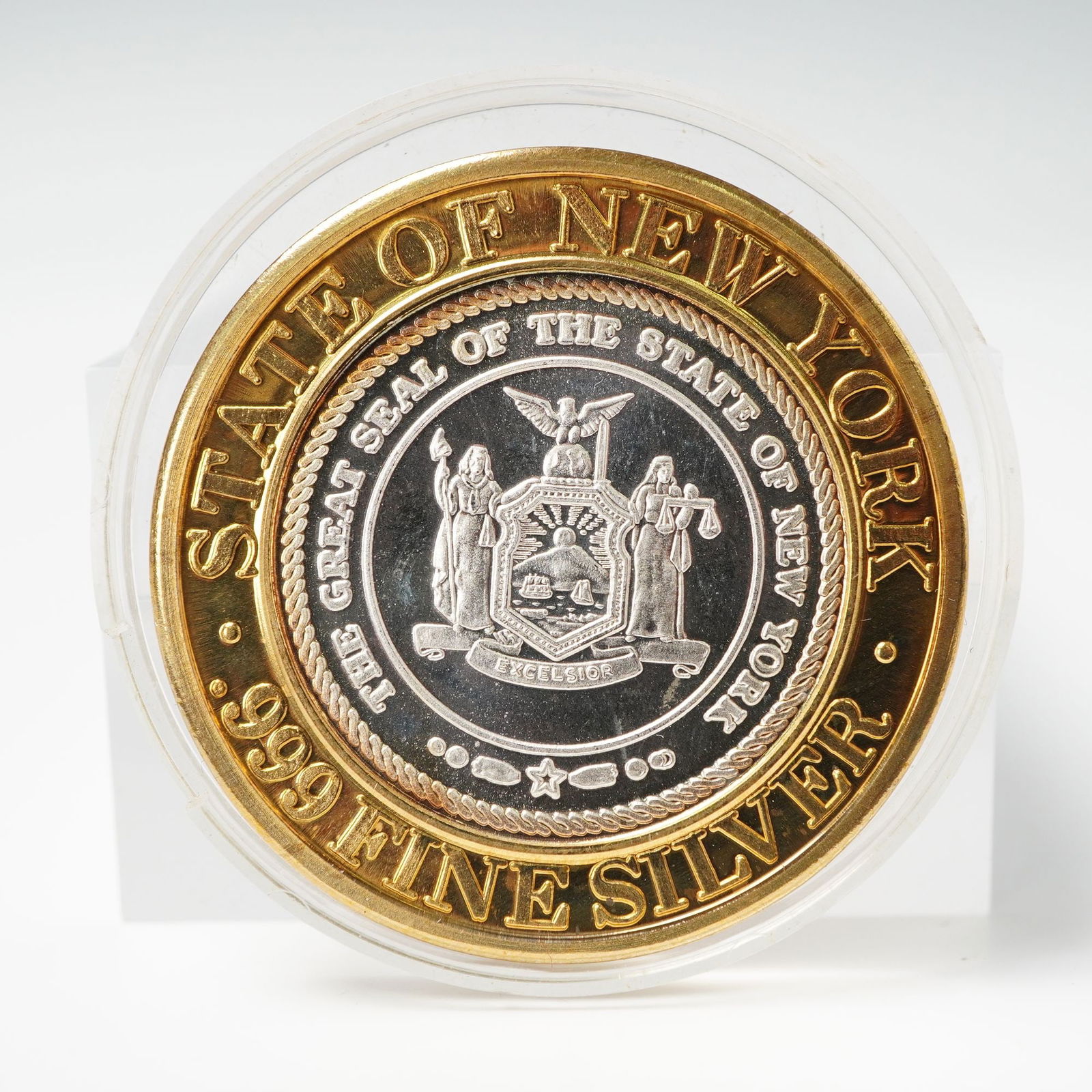 1994 Foxwoods Resort Casino State of New York $10 Gaming Token: A limited edition Foxwoods Resort Casino ten dollar gaming token issued in 1994, featuring fine silver center encircled by a brass outer ring. The obverse displays the Great Seal of the State of New