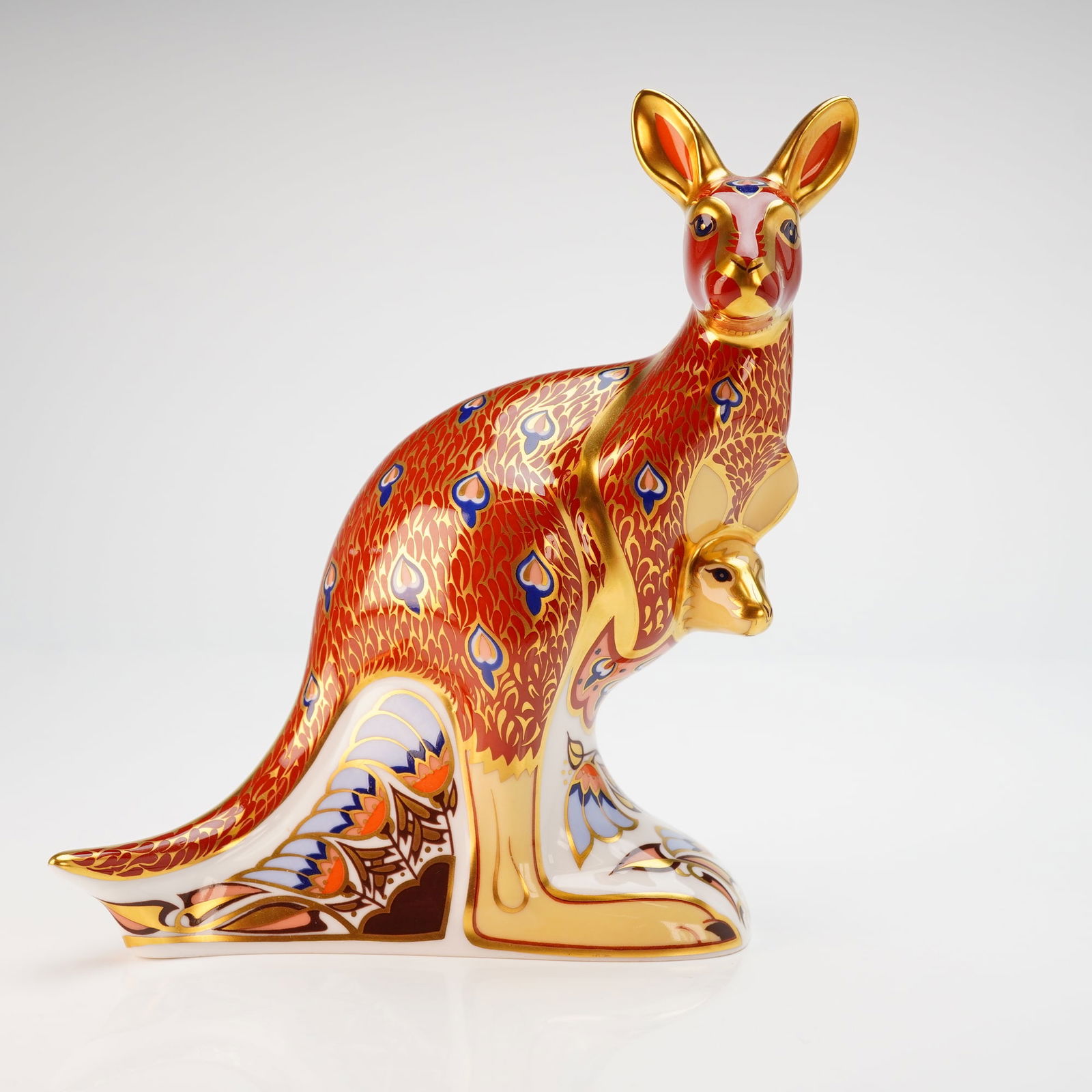 Royal Crown Derby Paperweight Kangaroo with Box: A Royal Crown Derby fine bone china figural paperweight titled Kangaroo from The Australian Collection. The piece depicts a kangaroo with a joey in its pouch, decorated in an Imari-style pattern with
