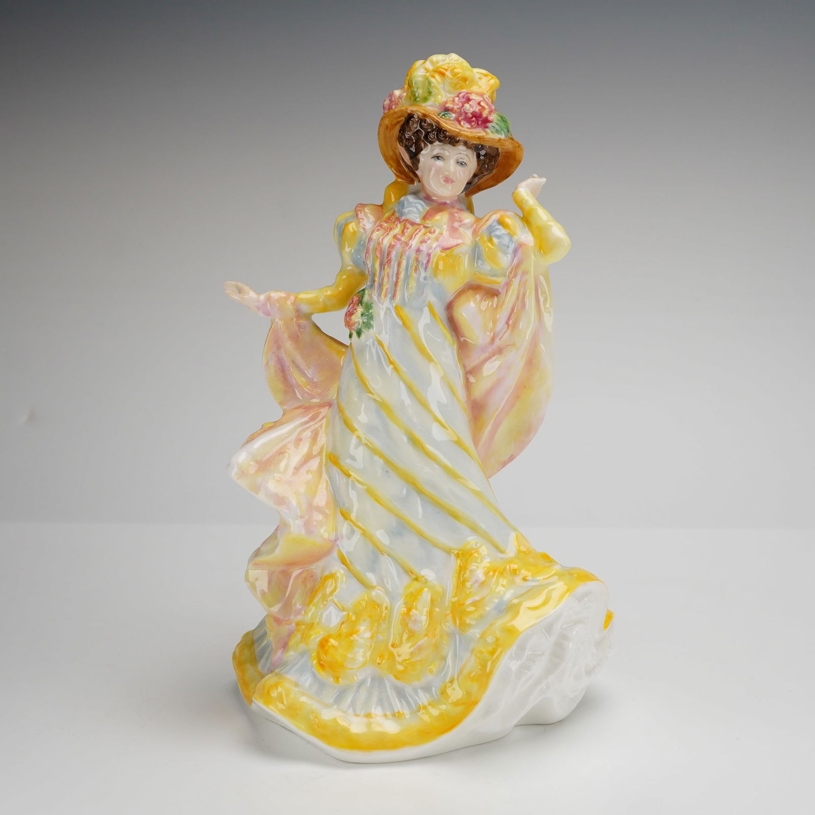 Royal Doulton Primrose Figurine HN 3710 Flowers of Love Collection: A Royal Doulton bone china figurine titled Primrose, model number HN 3710, from the Flowers of Love collection. This hand-decorated piece was modeled by Valerie Annand and is dated 1995. The figure is