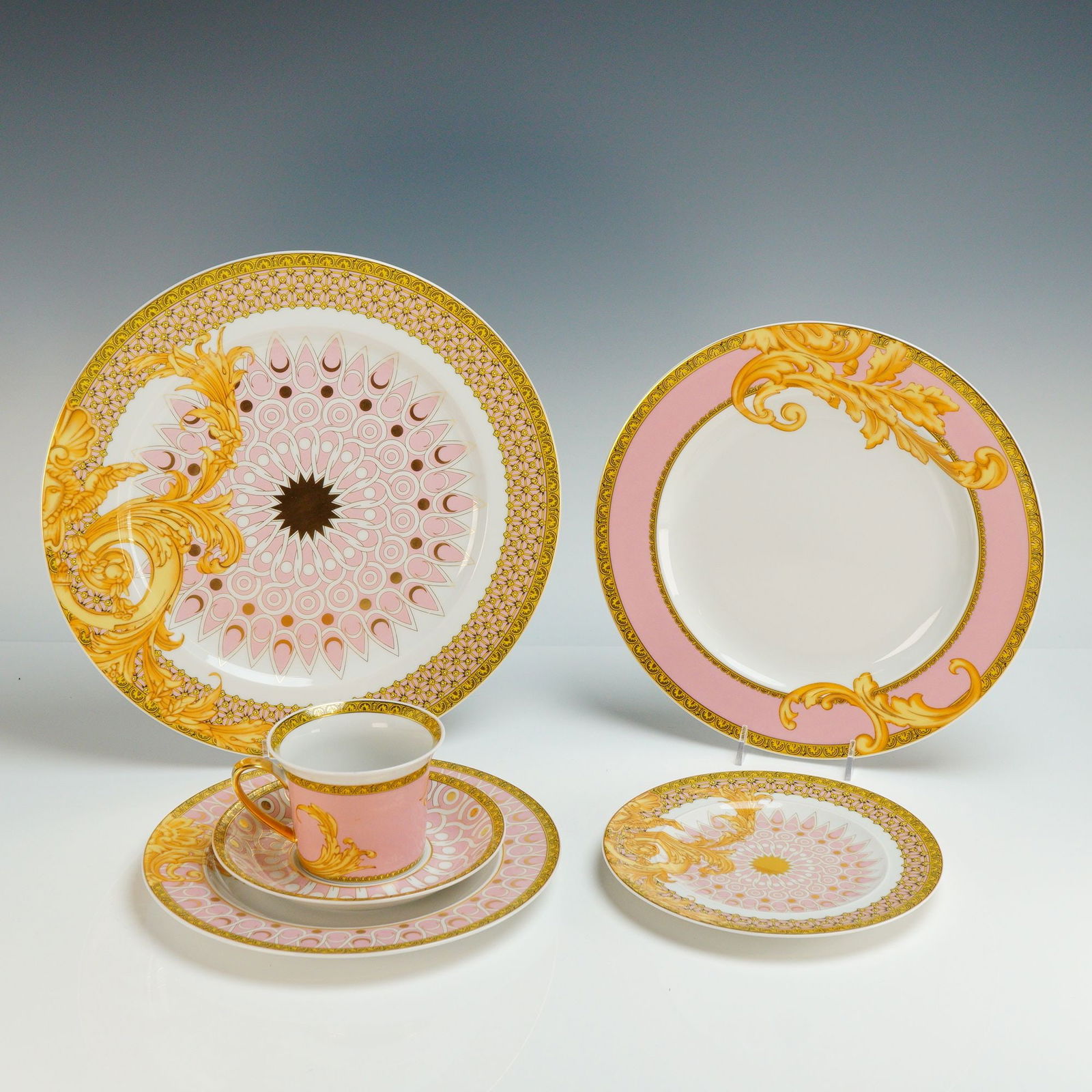 Versace Rosenthal 6-Piece Place Setting, Les Reves Byzantins: The items are crafted from white porcelain and decorated with a palette of pale pink and gold. The ornamentation includes intricate Byzantine-inspired geometric motifs alongside classic Barocco-style