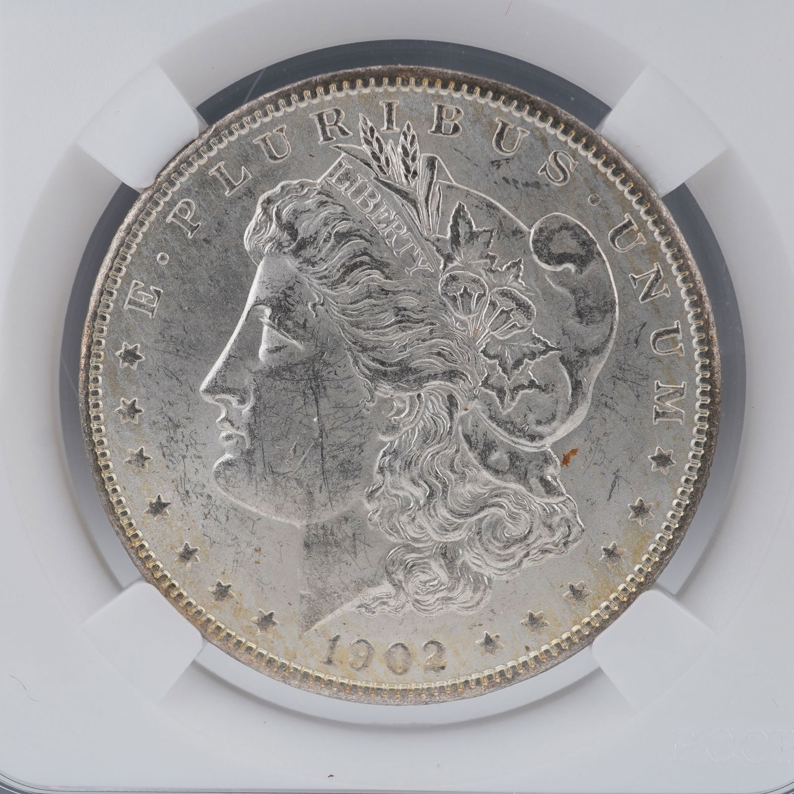 1902-O Morgan Silver Dollar: A 1902-O Morgan Silver Dollar, struck at the New Orleans Mint and composed of ninety percent silver. The obverse displays George T. Morgan's distinguished profile of Liberty wearing a Phrygian cap
