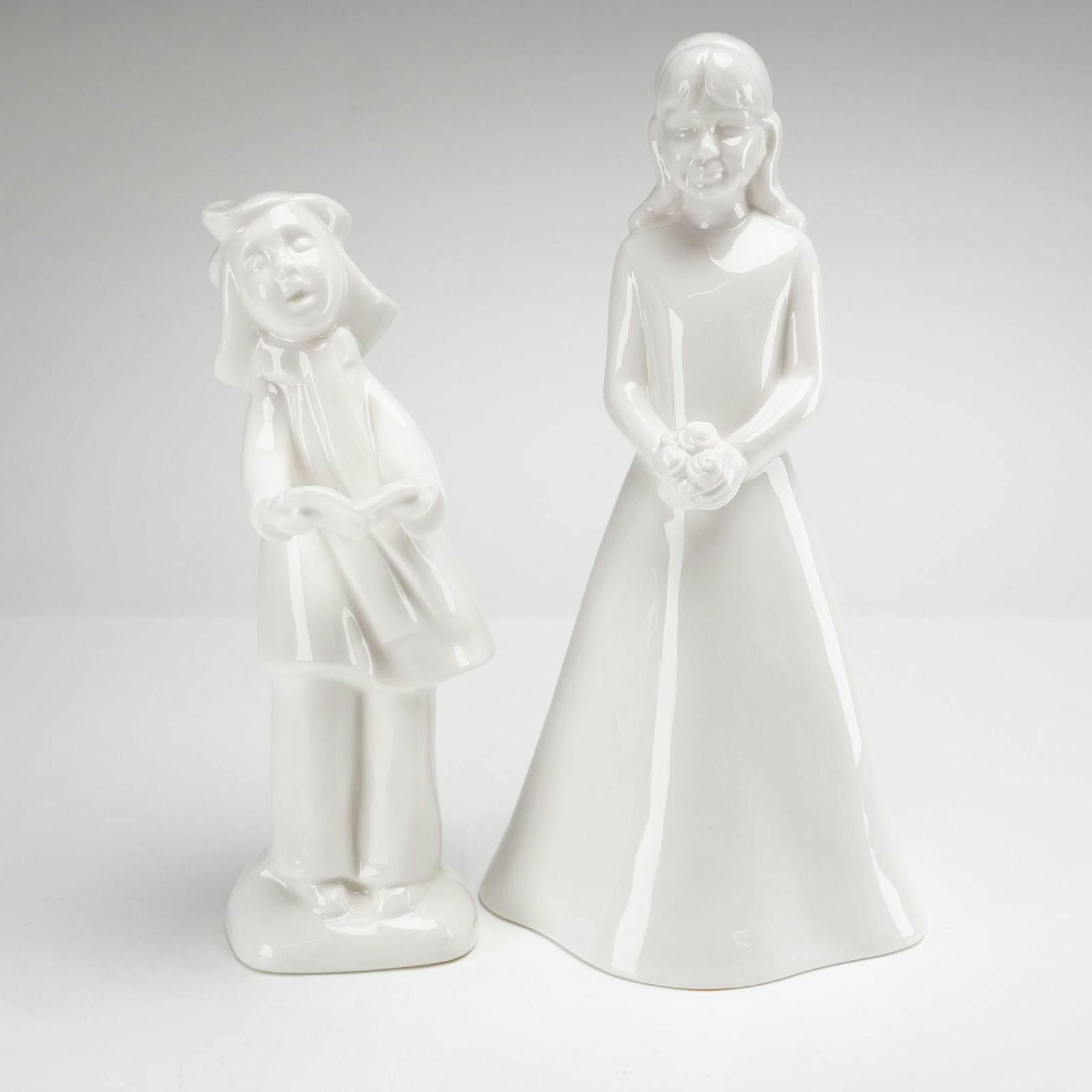 2pc Royal Doulton and Coalport Figurines: Two white glazed figurines. The first is a Royal Doulton porcelain figurine from the Images collection titled Christmas Choir Carol Singer-Sister, model HN 4291. This piece is a limited edition